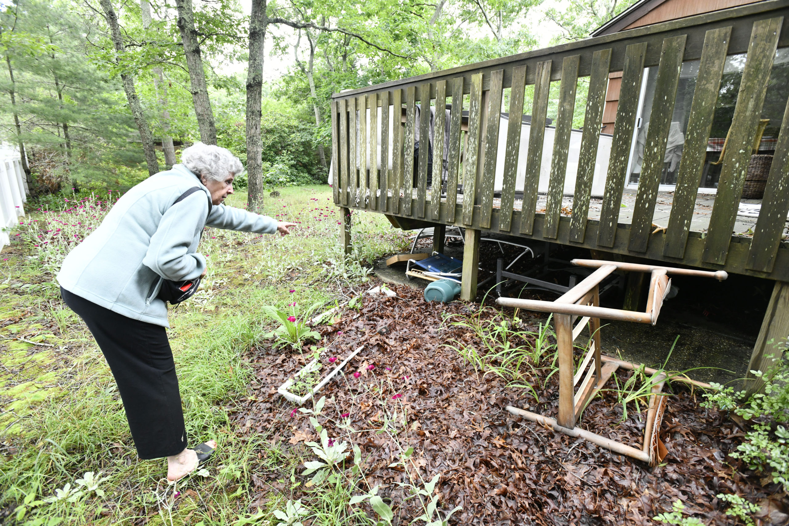 Genya Markon checks the surrounding property of her Hampton Bays home.   DANA SHAW
