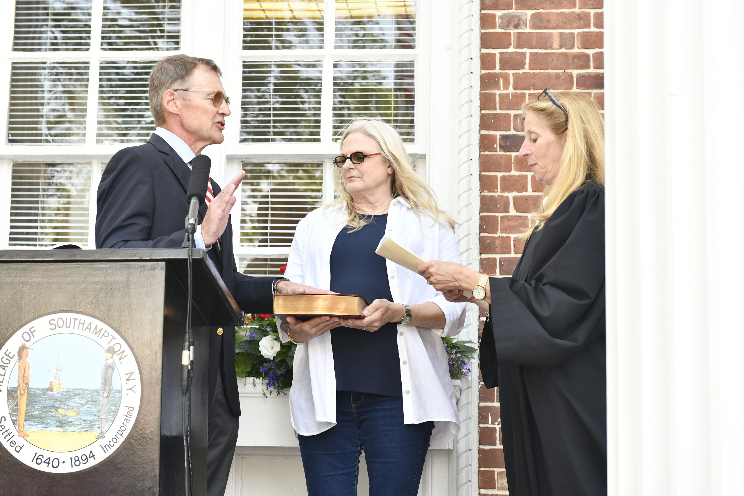 Southampton Village Trustee Roy Stevenson  is sworn in by Judge Barbara Wilson as his wife Polly holds the Bible at Village Hall on Tuesday evening.   DANA SHAW