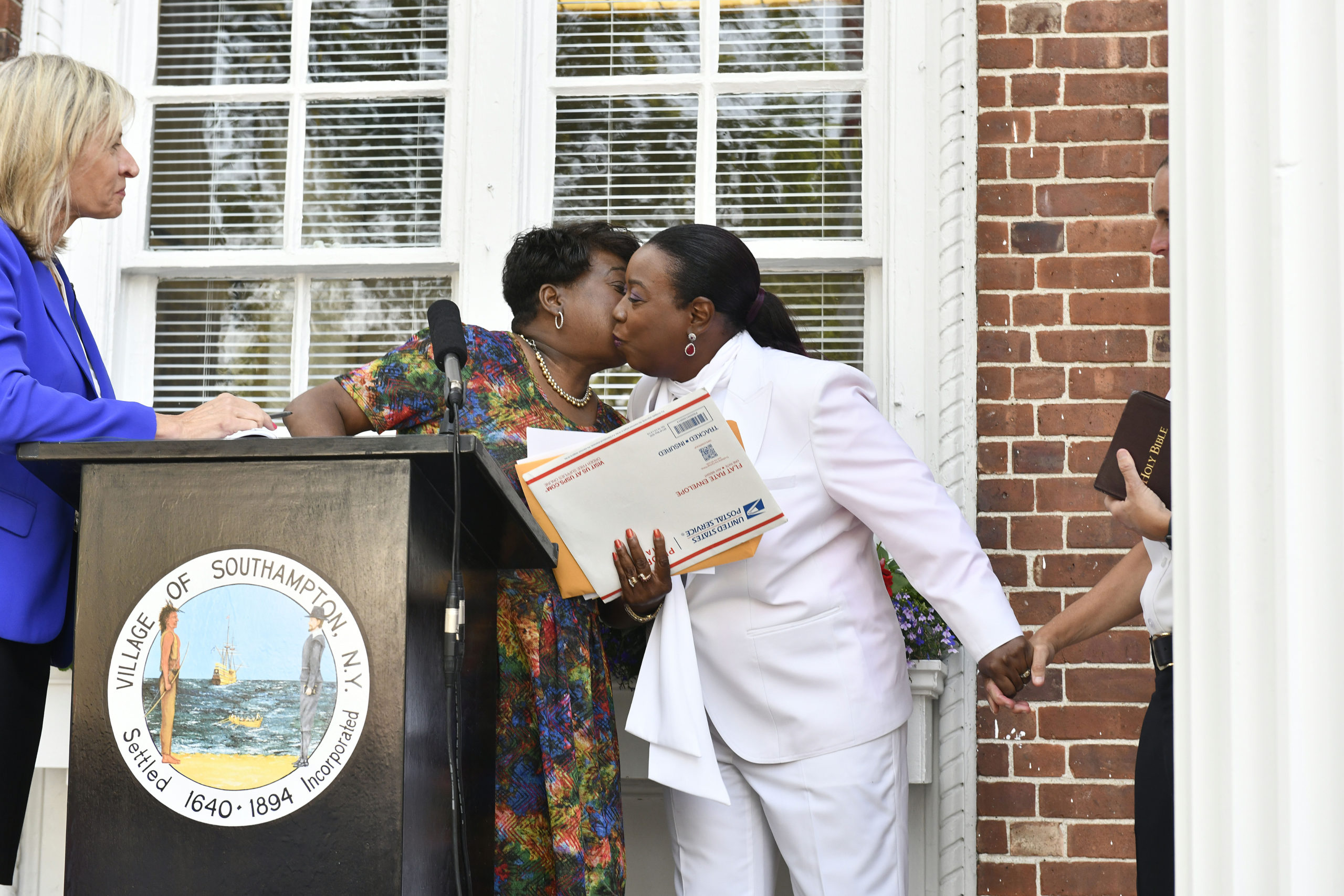 Southampton Village Trustee Robin Brown kisses her  cousin Nassau County District Court Judge Andrea Phoenix, who swore her in at Village Hall on Tuesday evening.   DANA SHAW