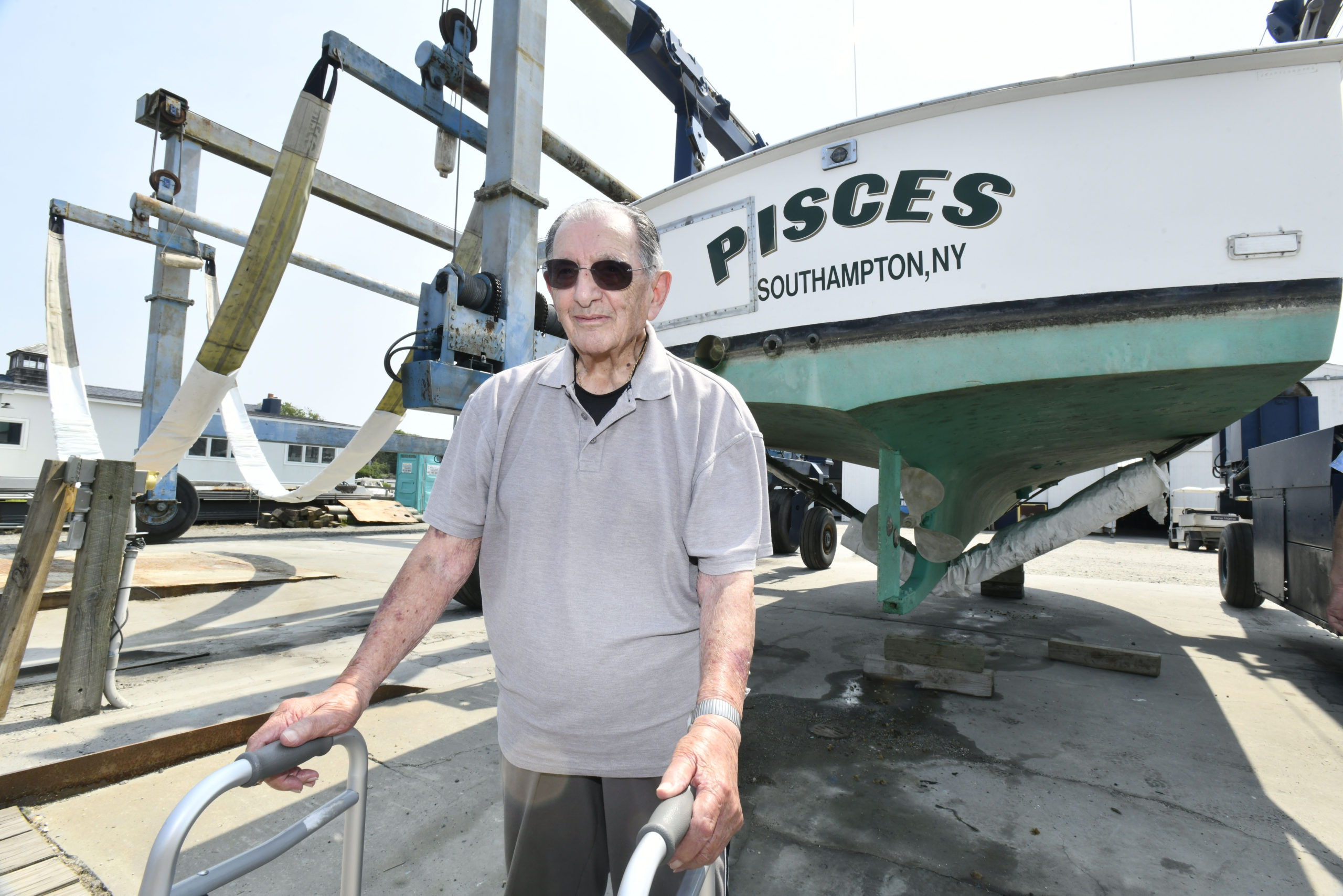 Anthony Rispoli with his boat, the Pisces.   DANA SHAW