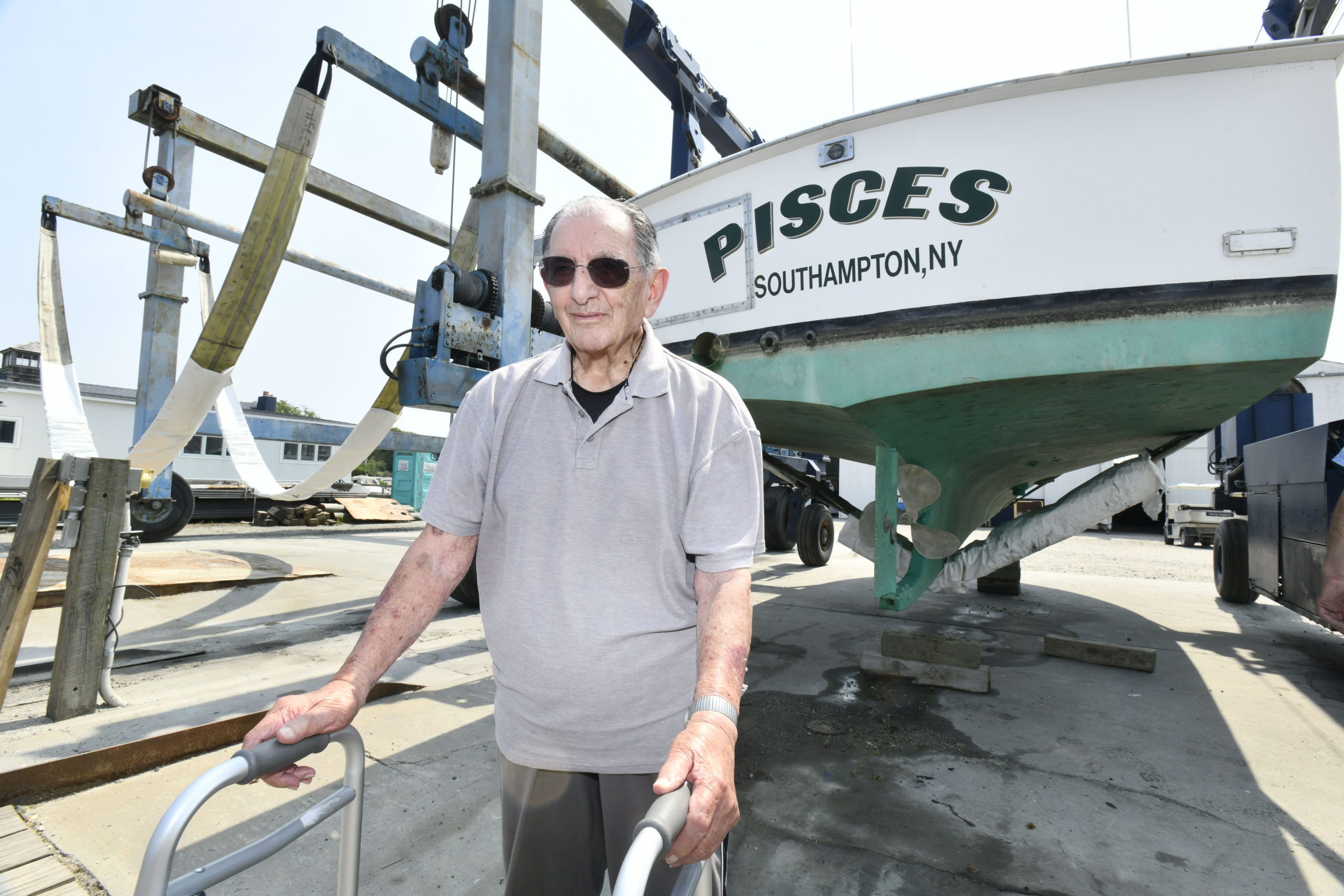 Anthony Rispoli with his boat, the Pisces.   DANA SHAW
