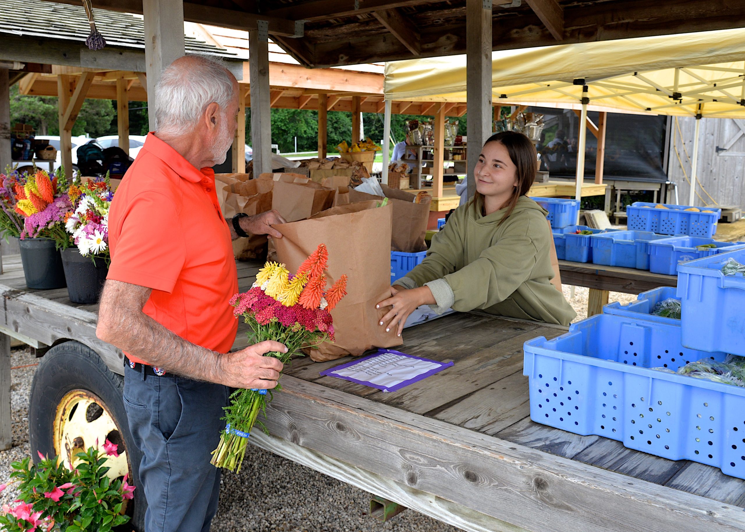 Emily Hecht serves a customer at Balsam Farms.