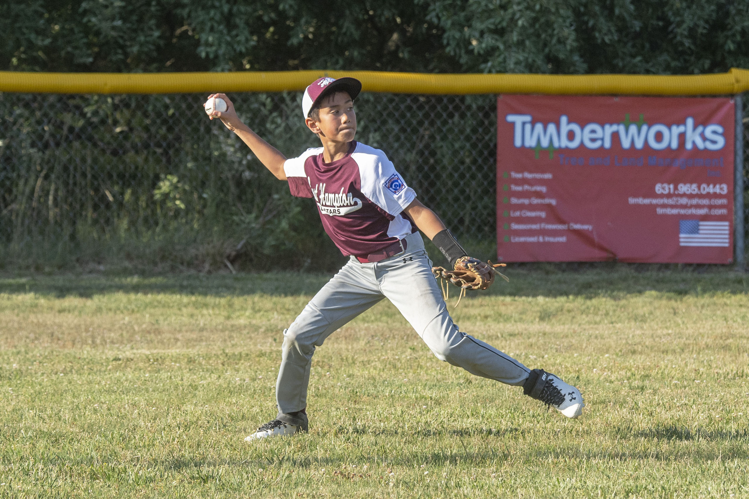 East Hampton's Miles Eckardt gets the ball in from left field.  MICHAEL HELLER