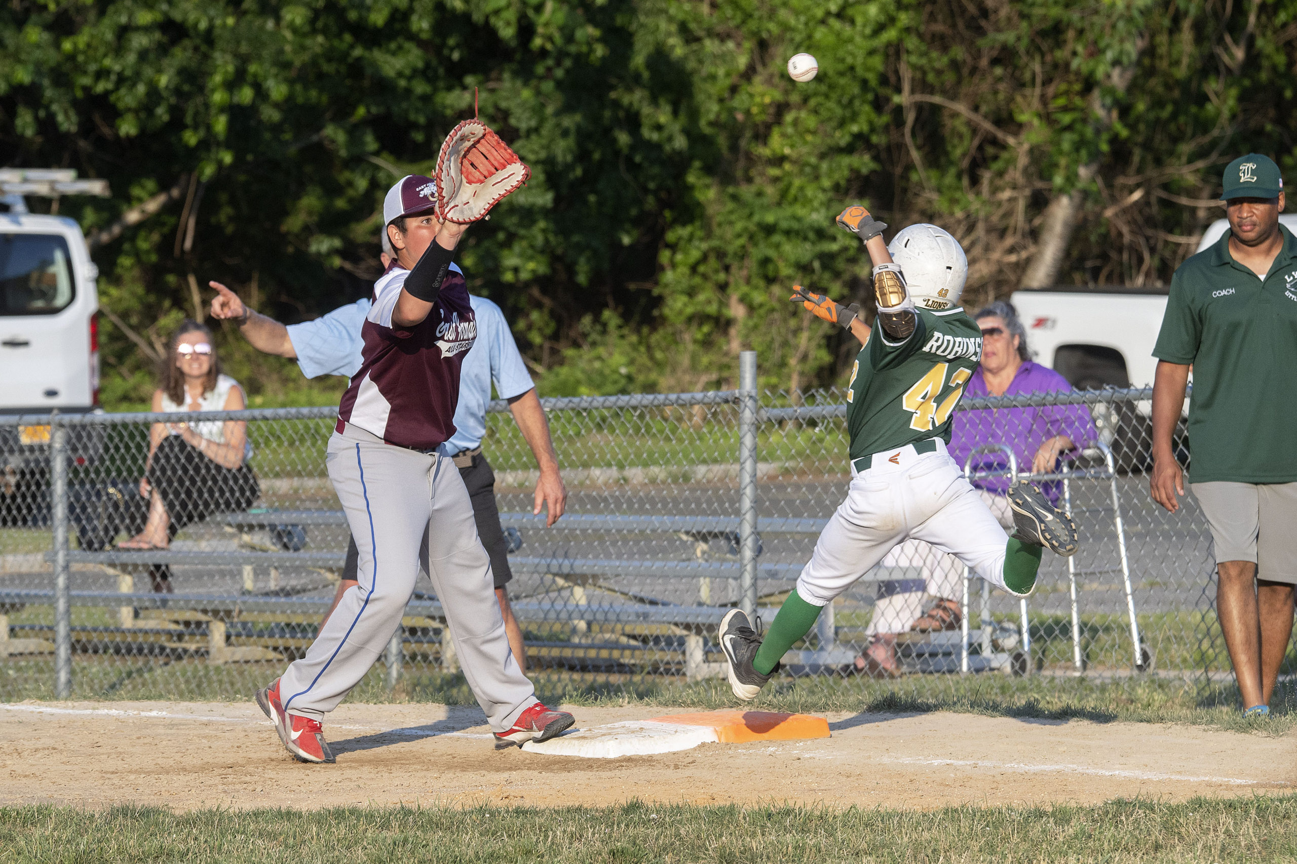 East Hampton's Trevor Meehan makes the out at first base.