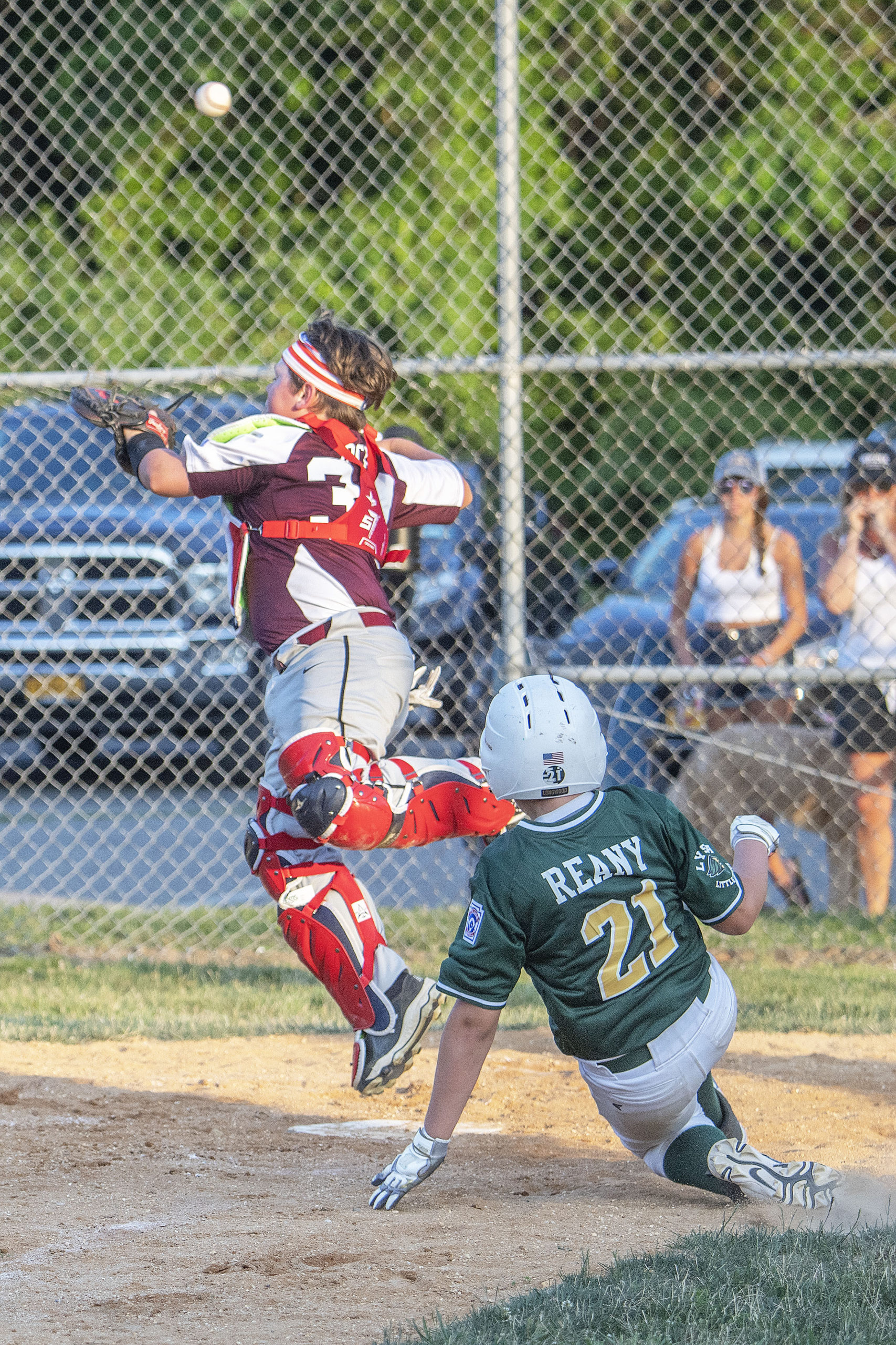 The throw comes in too high for East Hampton catcher Tucker Bock to make the play at home allowing a Longwood player to score.