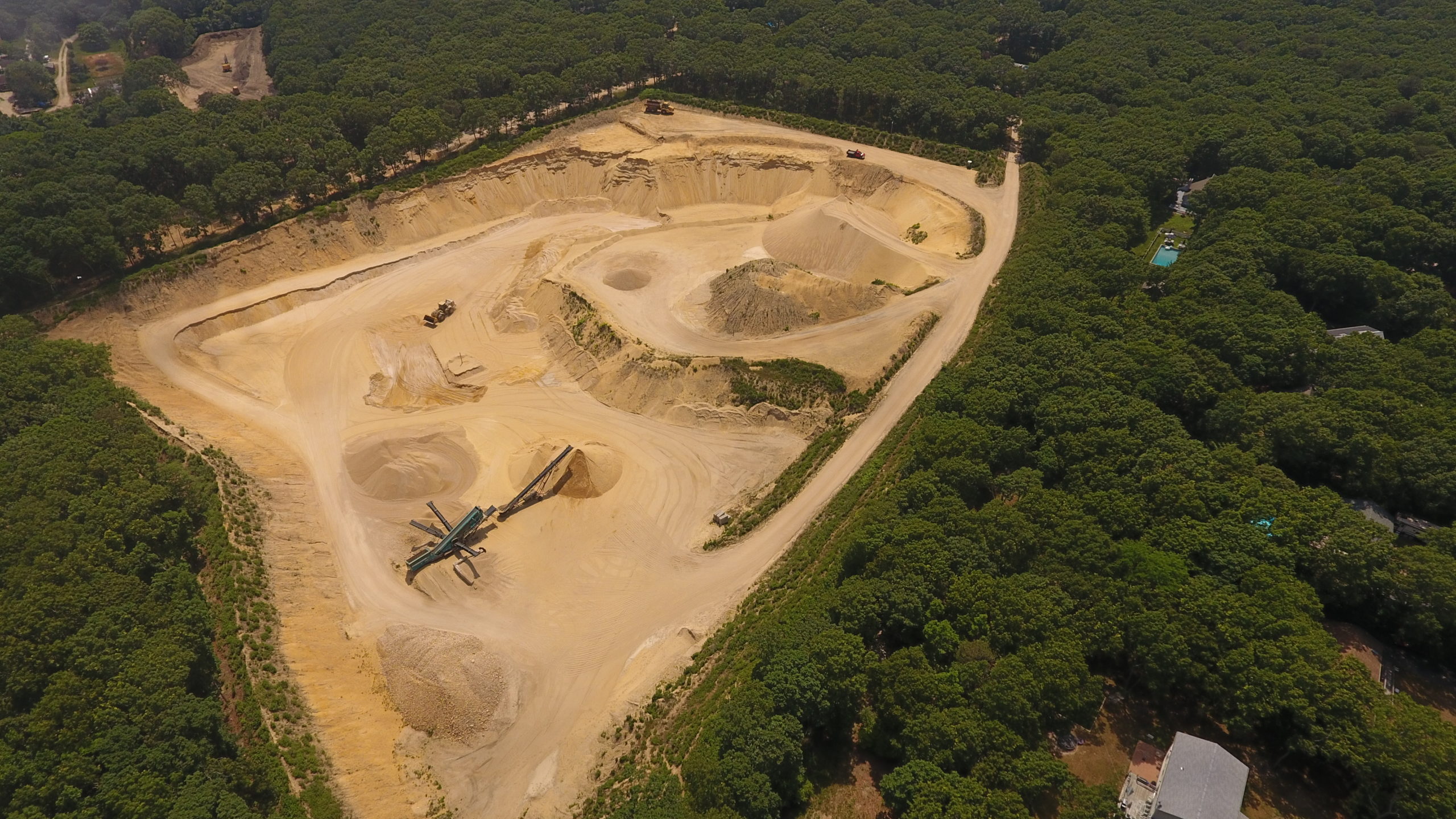 The sand pit on Middle Highway in East Hampton known as Sand Highway. A state judge this week ruled that allowing the mine to dig down 150 feet, creating a 6-acre lake of exposed groundwater, does not constitute an expansion of the mine. But another state court ruled in May that a similar proposal in Noyac was, in fact, an illegal expansion.