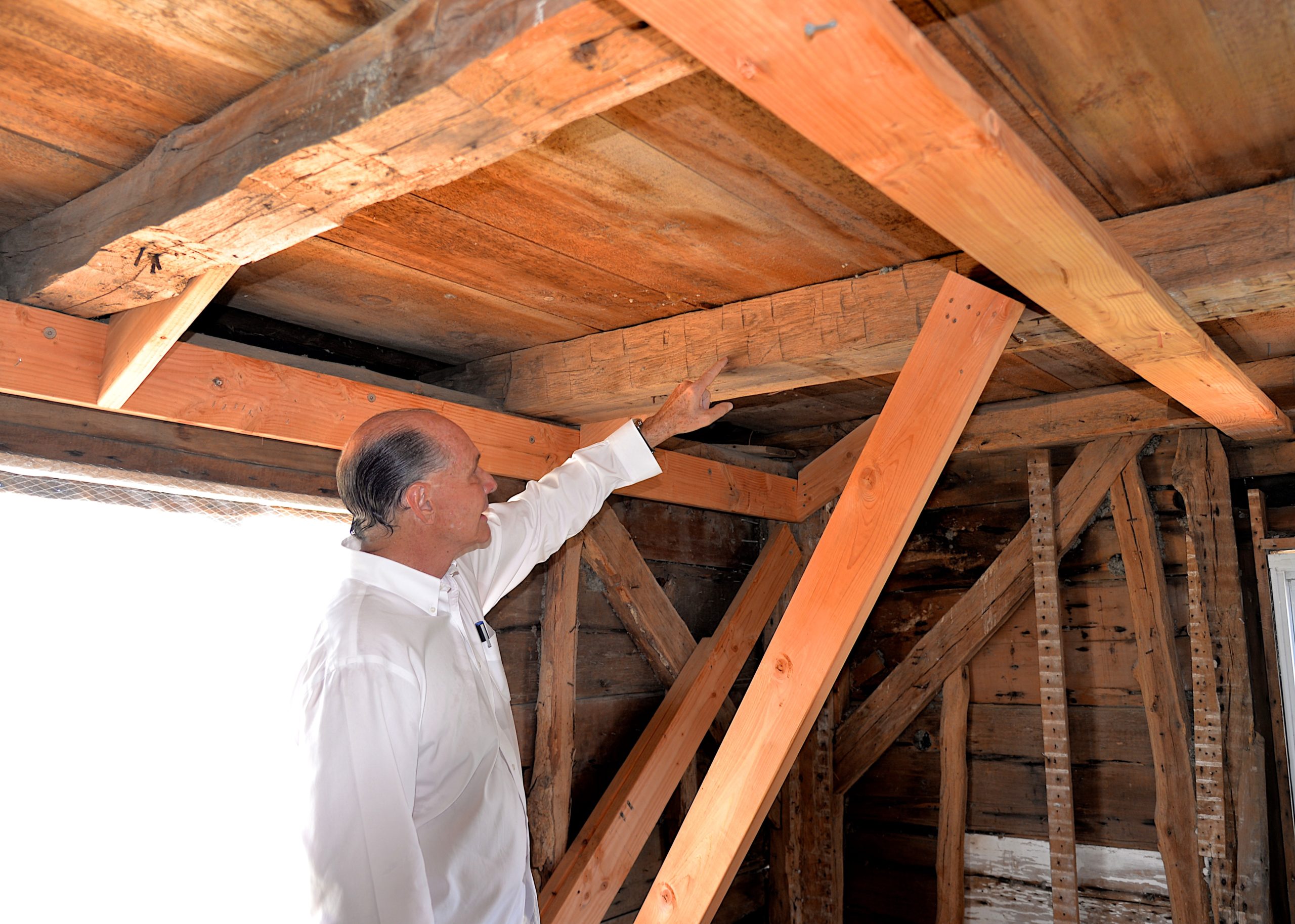 Jeffrey Colle shows off the hand-hewn beams in the historic home.KYRIL BROMLEY