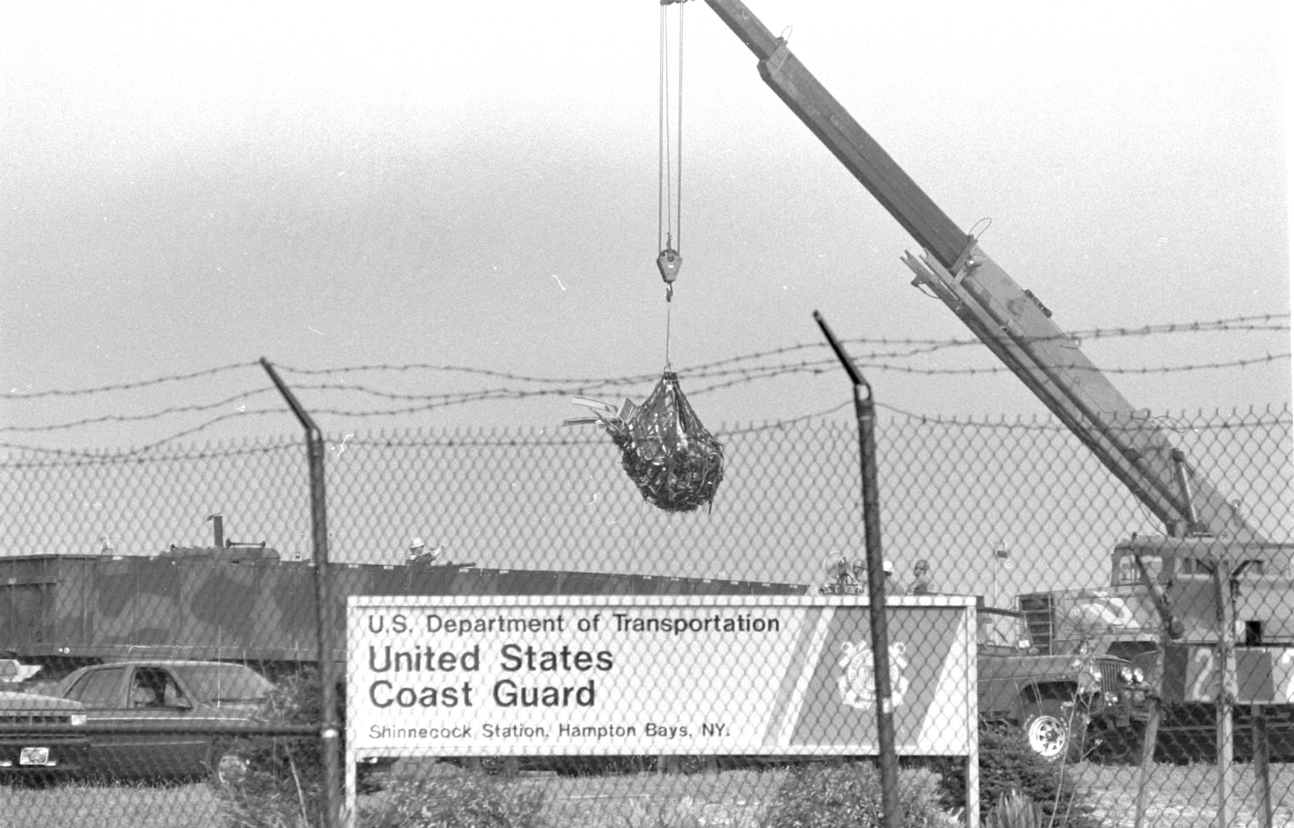 Wreckage from the plane is loaded onto trucks at the Shinnecock Coast Guard Station to be taken to hangar in Calverton and reassembled.  EXPRESS FILE