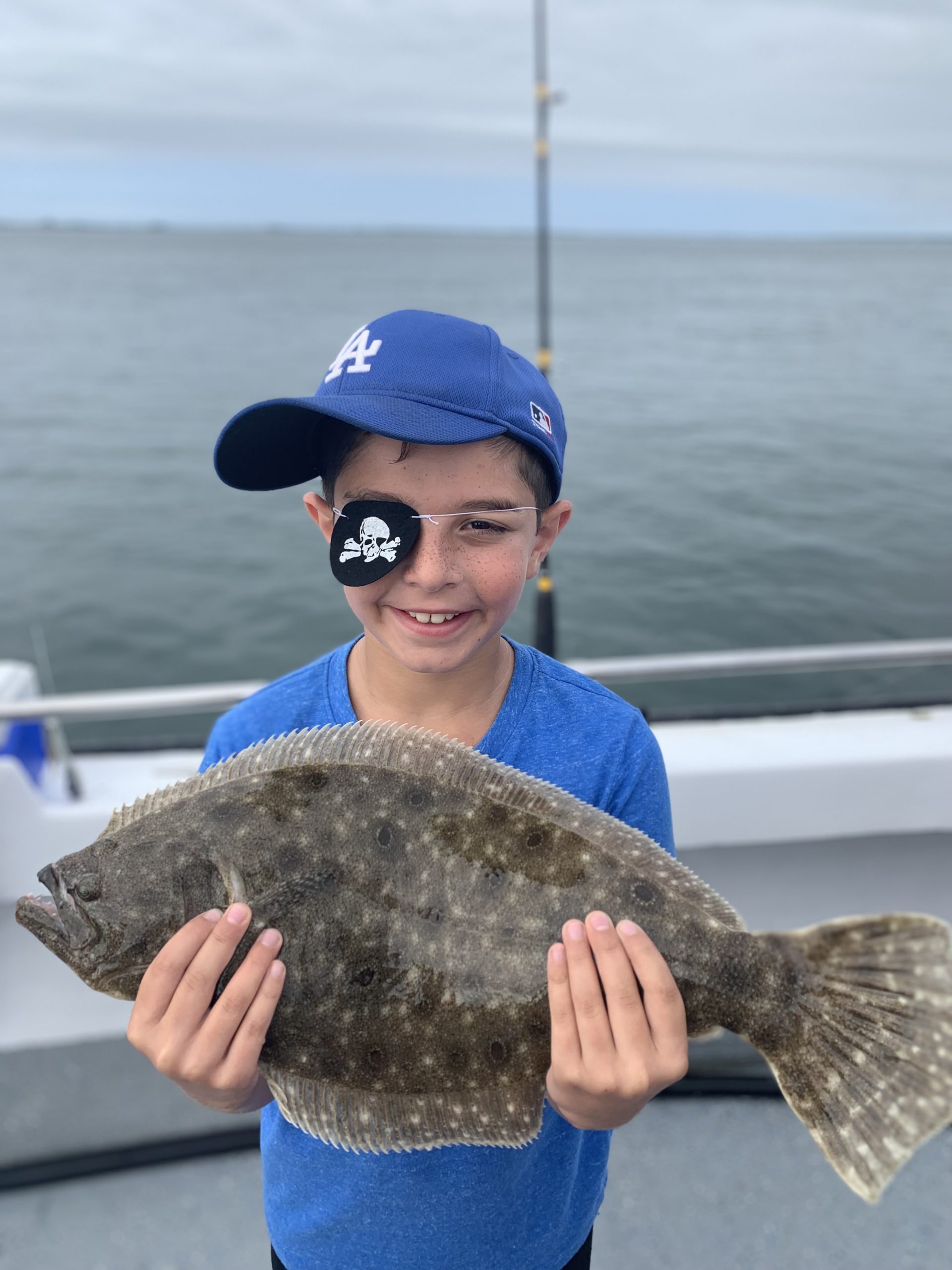 Tommy Savastano, fluke pirate extraordinaire, with the plunder from a recent trip aboard the Shinnecock Star with his cousin Deena Lippman.