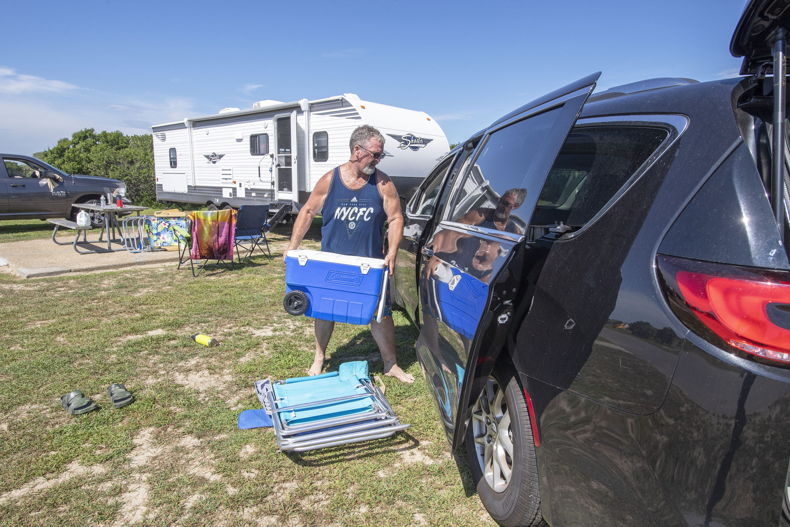 Kenny Trumbull loads up his car as he breaks down his campsite in Hither Hills State Park in Montauk in preparation for Hurricane Henri on Saturday.   MICHAEL HELLER