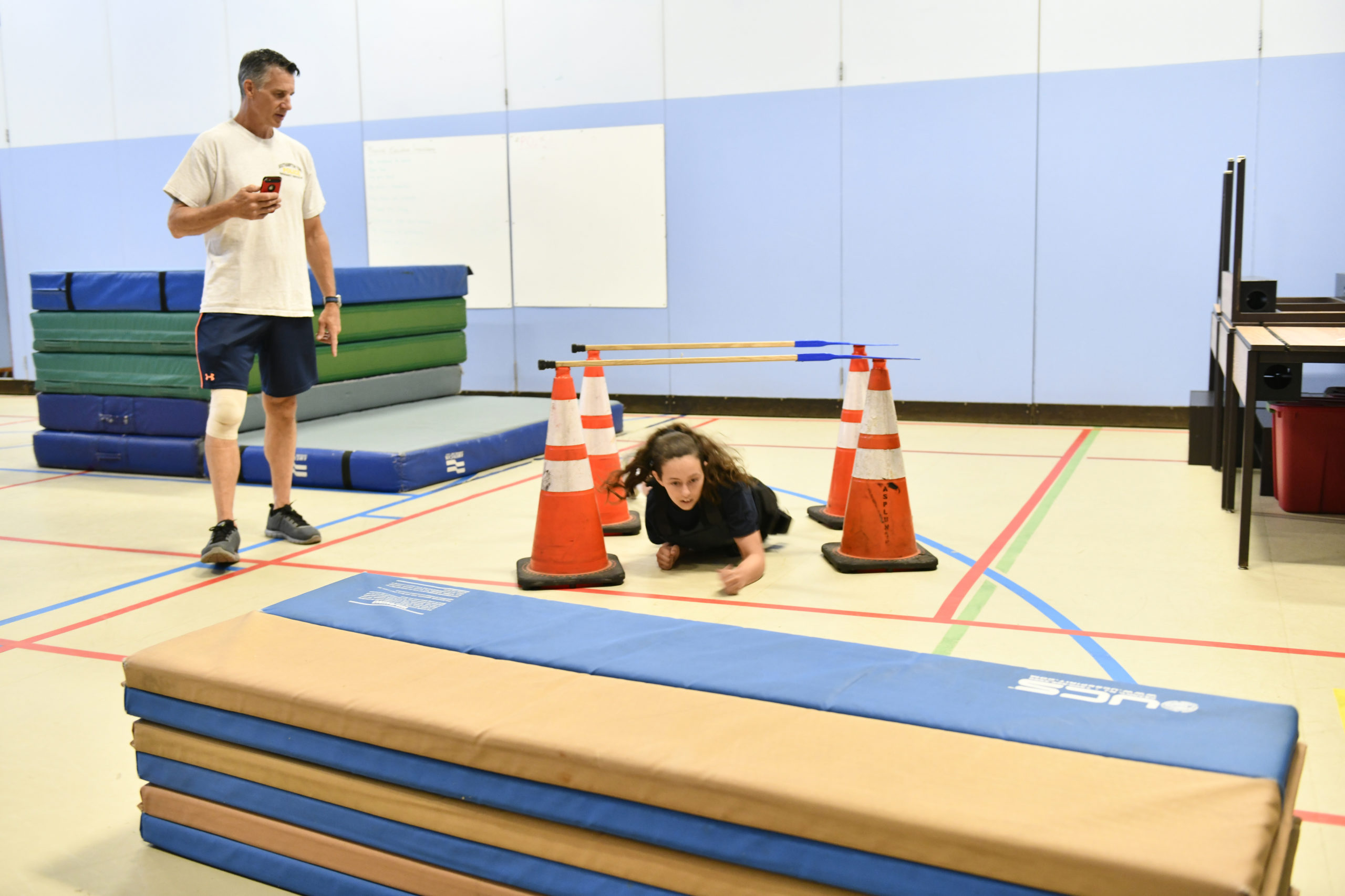 Lt. Todd Spencer times Nicole Scourakis in the Youth Academy challenge course.