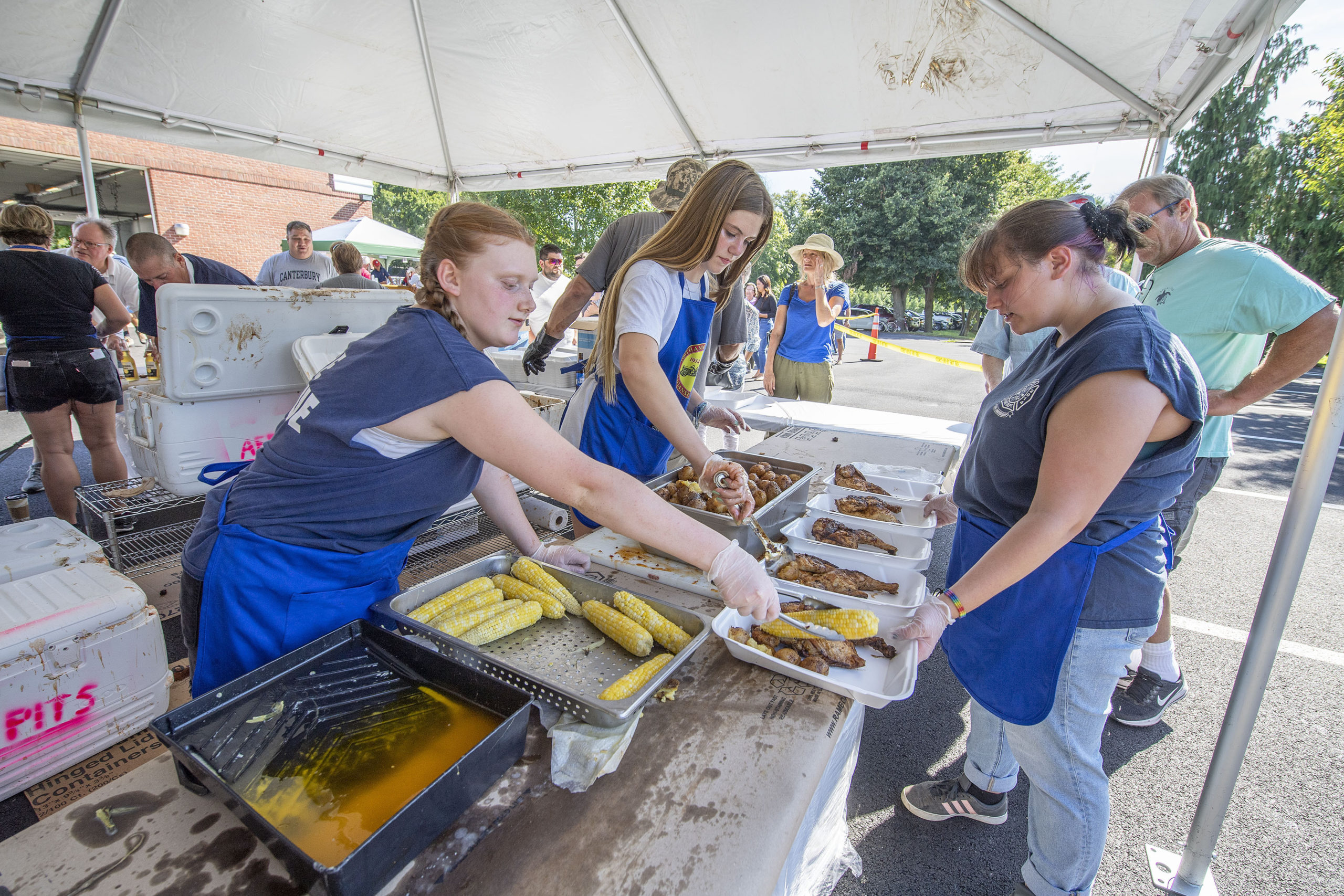 Fresh local corn-on-the-cob was part of the serving during the annual Amagansett Fire Department Chicken Bar-b-que fundraiser on Sunday afternoon.  MICHAEL HELLER