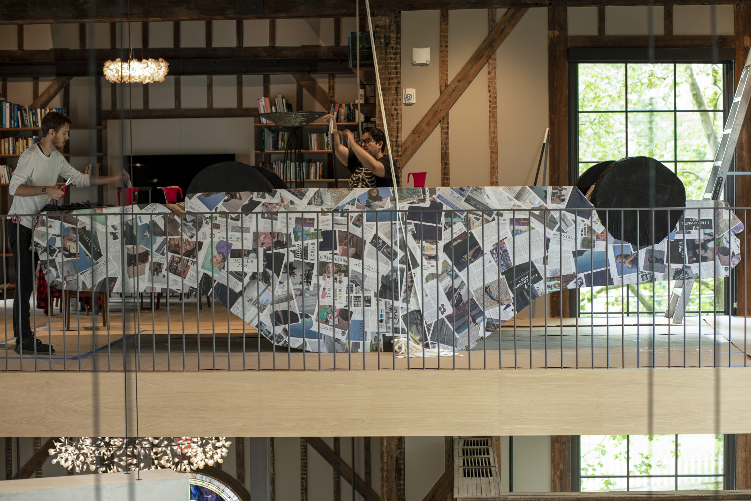 Artist Justin Favela, center, works at The Church with Thomas Willis, left, in the creation of the low-rider ’64 Chevy Impala made in piñata style.
