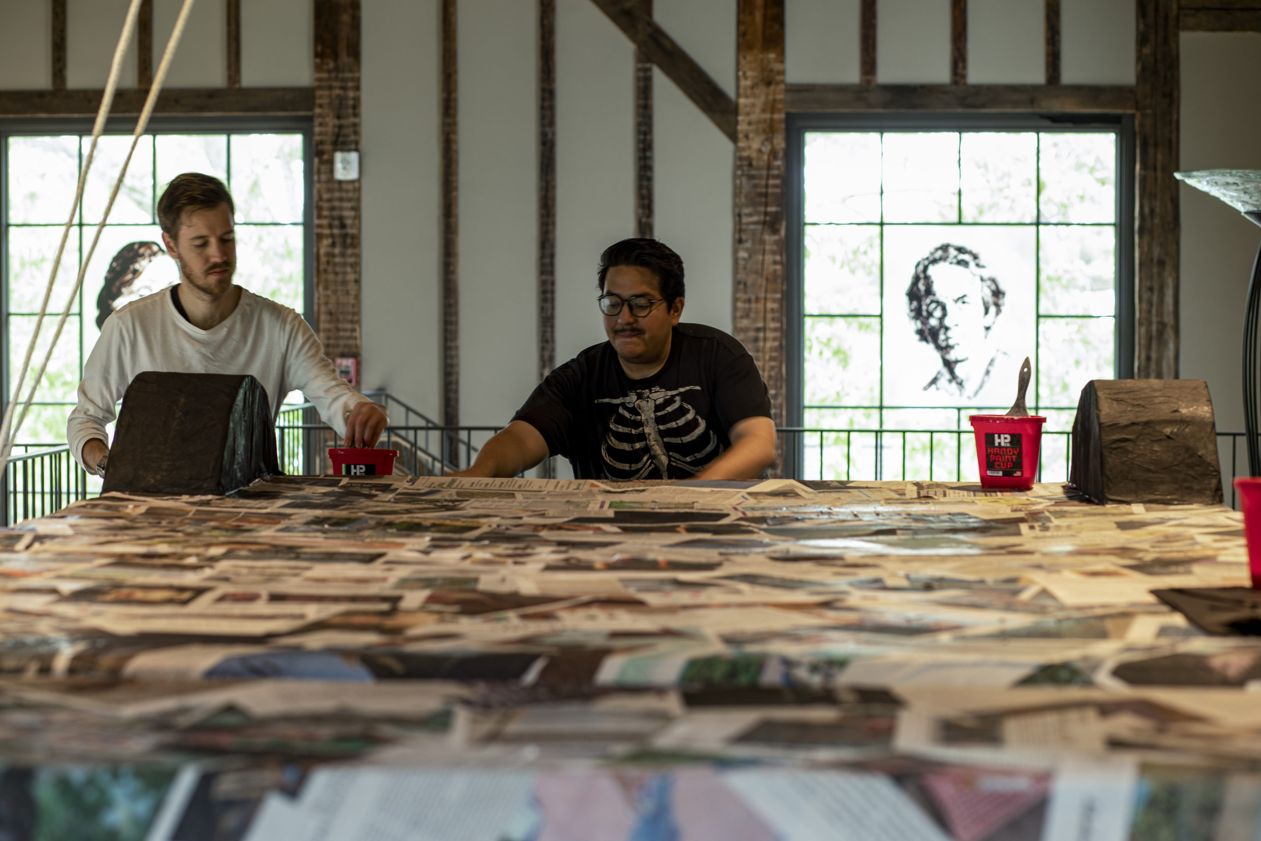 Artist Justin Favela, center, works at The Church with Thomas Willis, left, in the creation of the low-rider ’64 Chevy Impala made in piñata style.