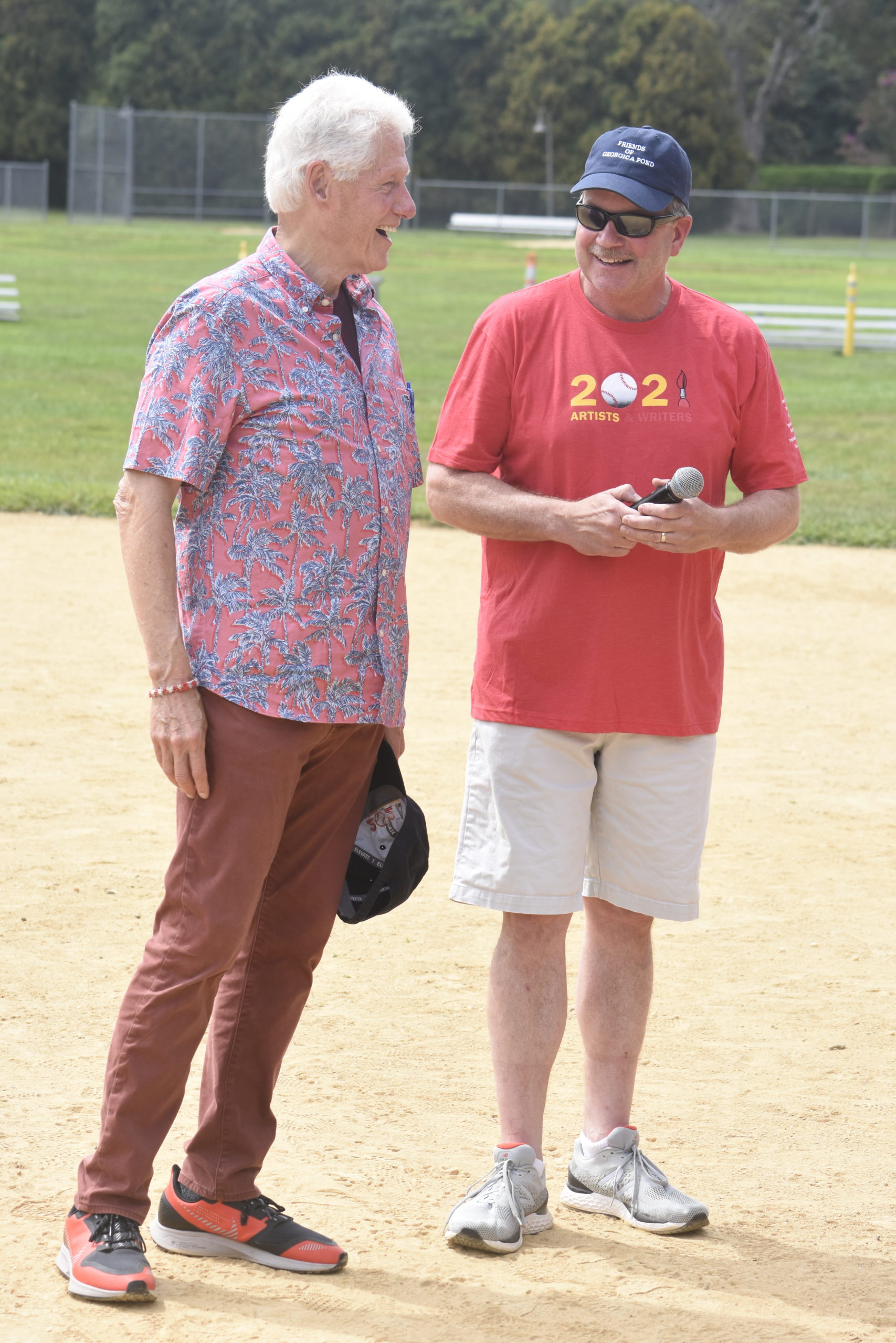 Former president Bill Clinton and East Hampton Village Mayor Jerry Larsen share a laugh before the start of the game.