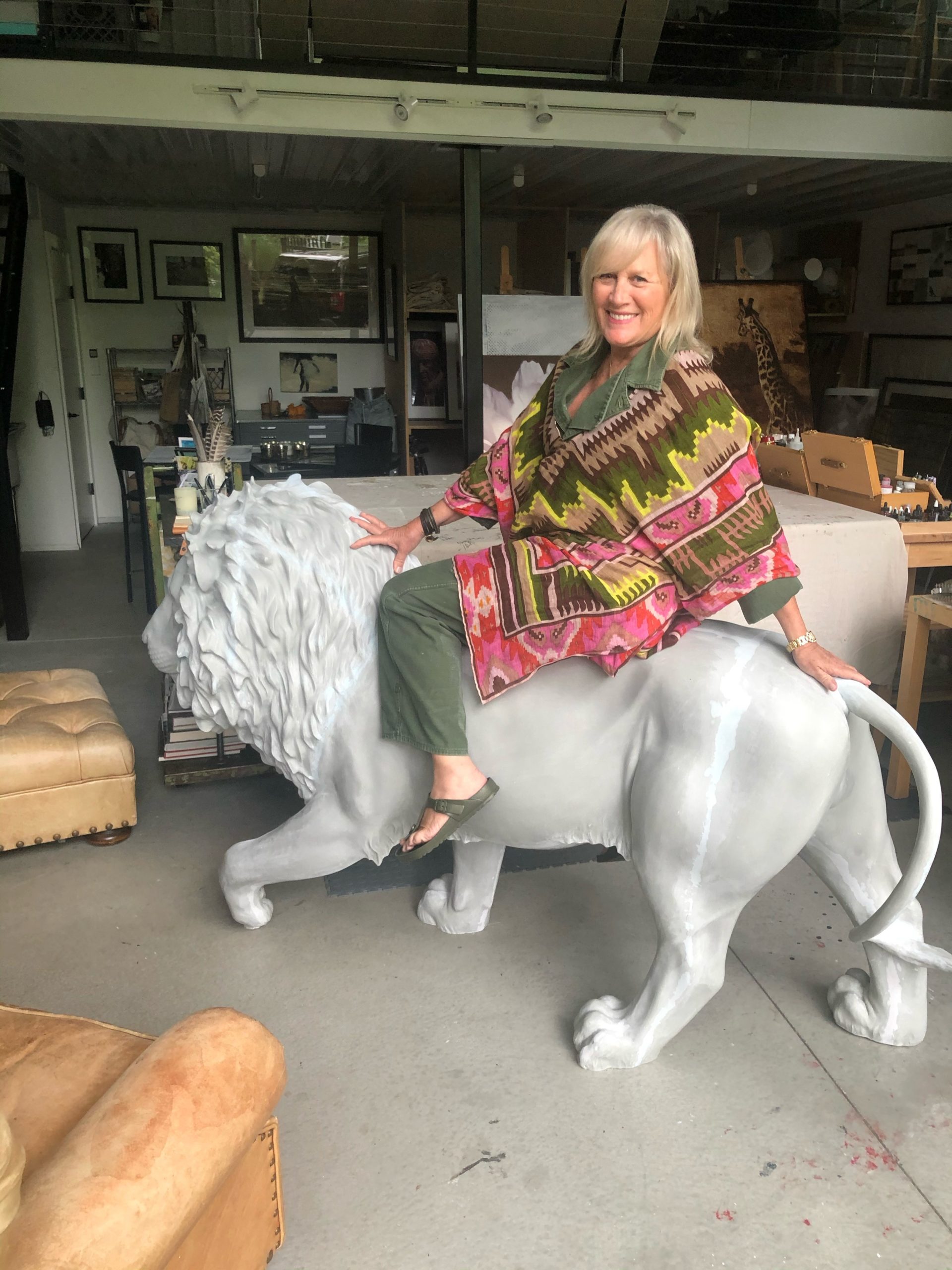 Beth O’Donnell atop her lion sculpture.