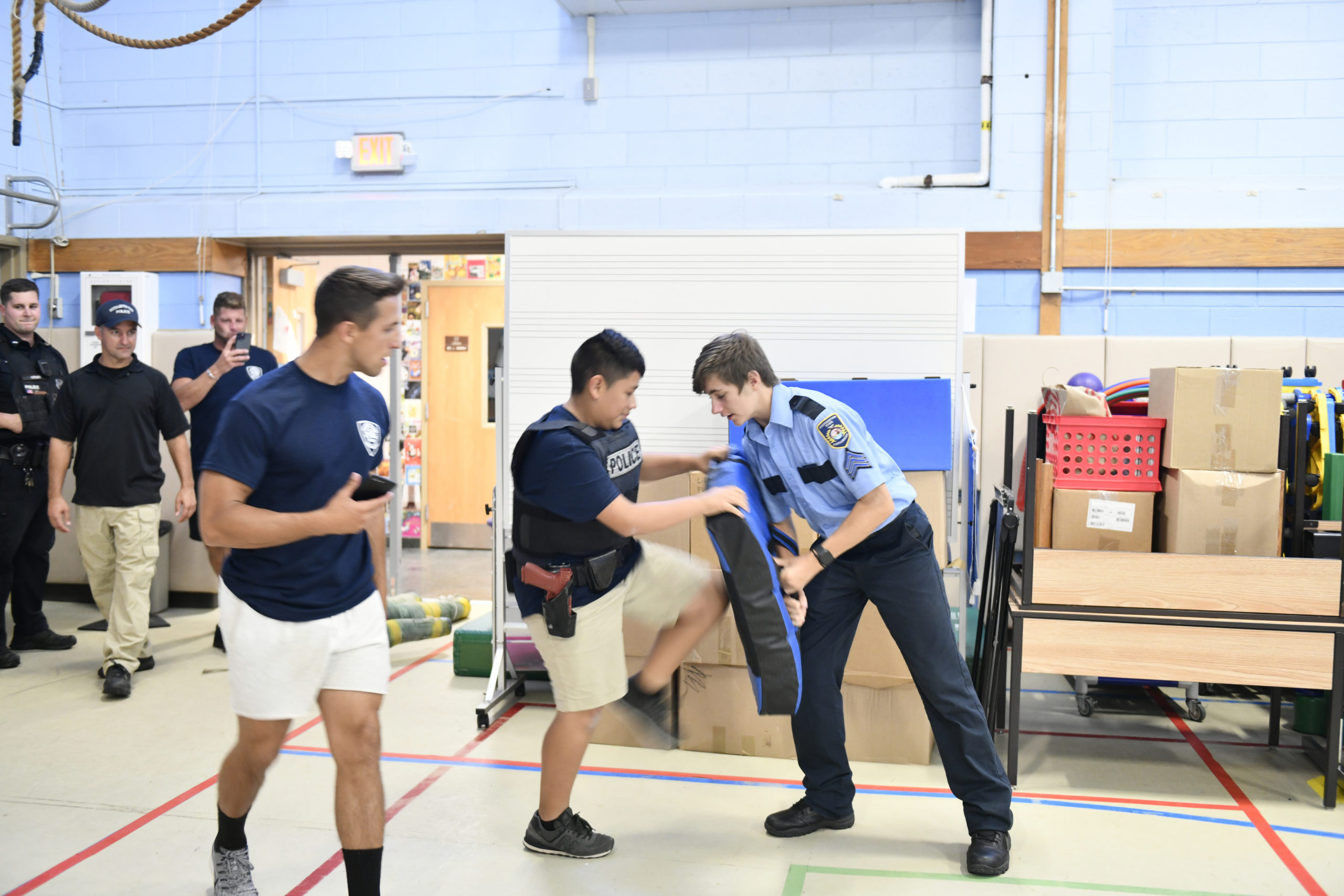 Explorer  Sgt John Lennon holds the practice pad as Josue Wazhima kicks through the physical challenge.