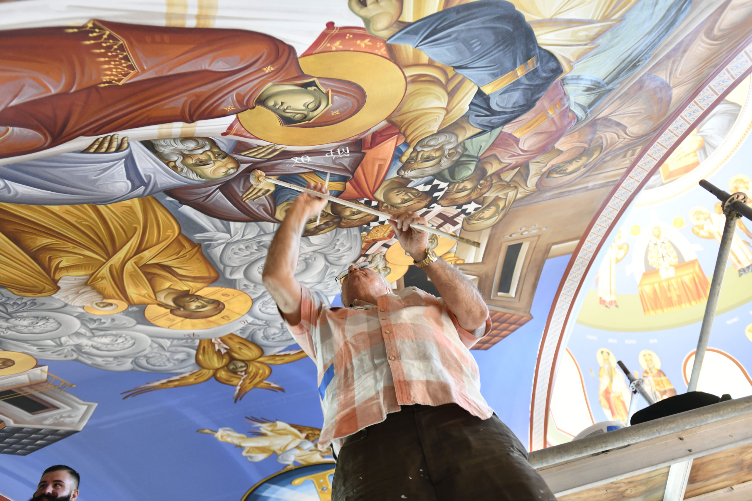 Iconographer George Filippakis works on the ceiling of the Dormition of the Virgin Mary Greek Orthodox Church on Monday. The church will be his last work.  DANA SHAW