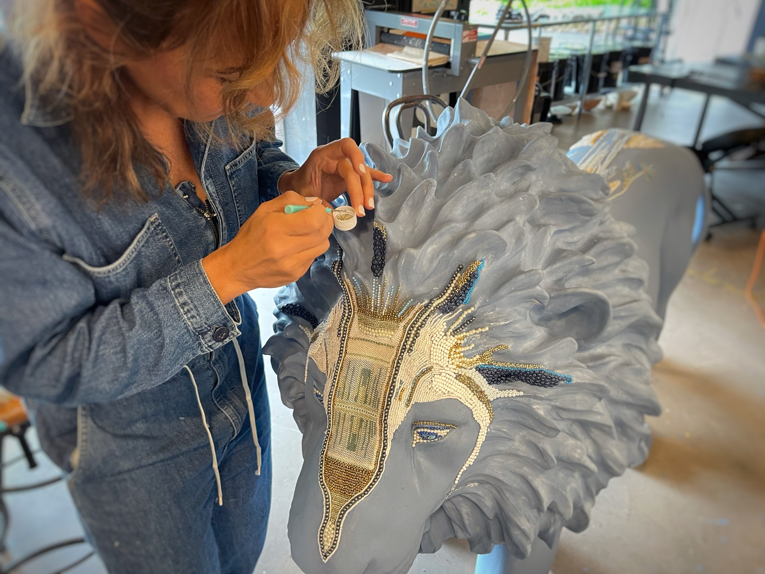 Elizabeth Jordan works on her lion sculpture, 