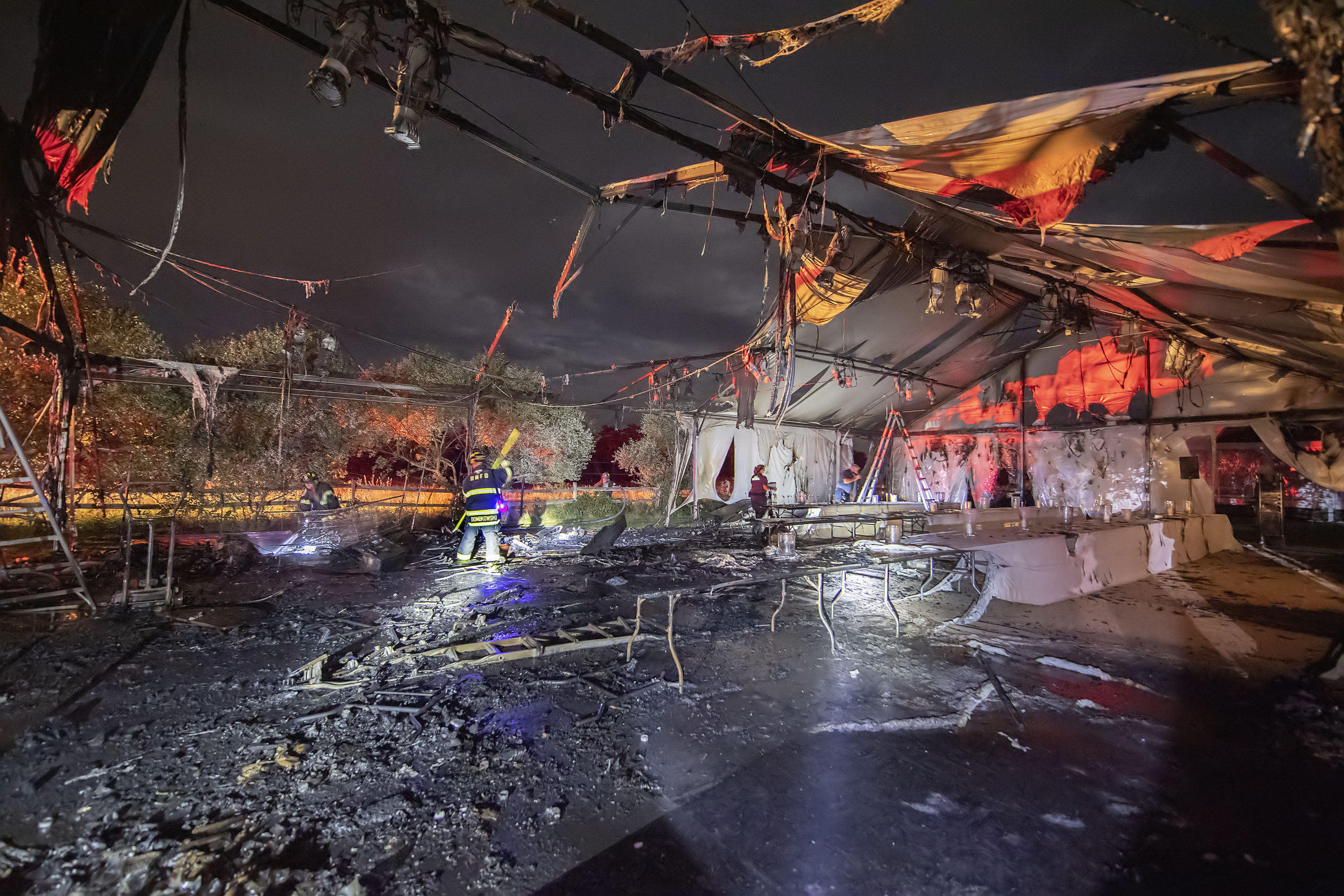 Fire swept through a large party tent Friday behind a home on Lockwood Avenue in Bridgehampton. The Bridgehampton Fire Department, with help from Sag Harbor and East Hampton firefighters, extinguished the blaze, and the party, scheduled for Saturday, went on in a second tent that had already been erected for the event. MICHAEL HELLER