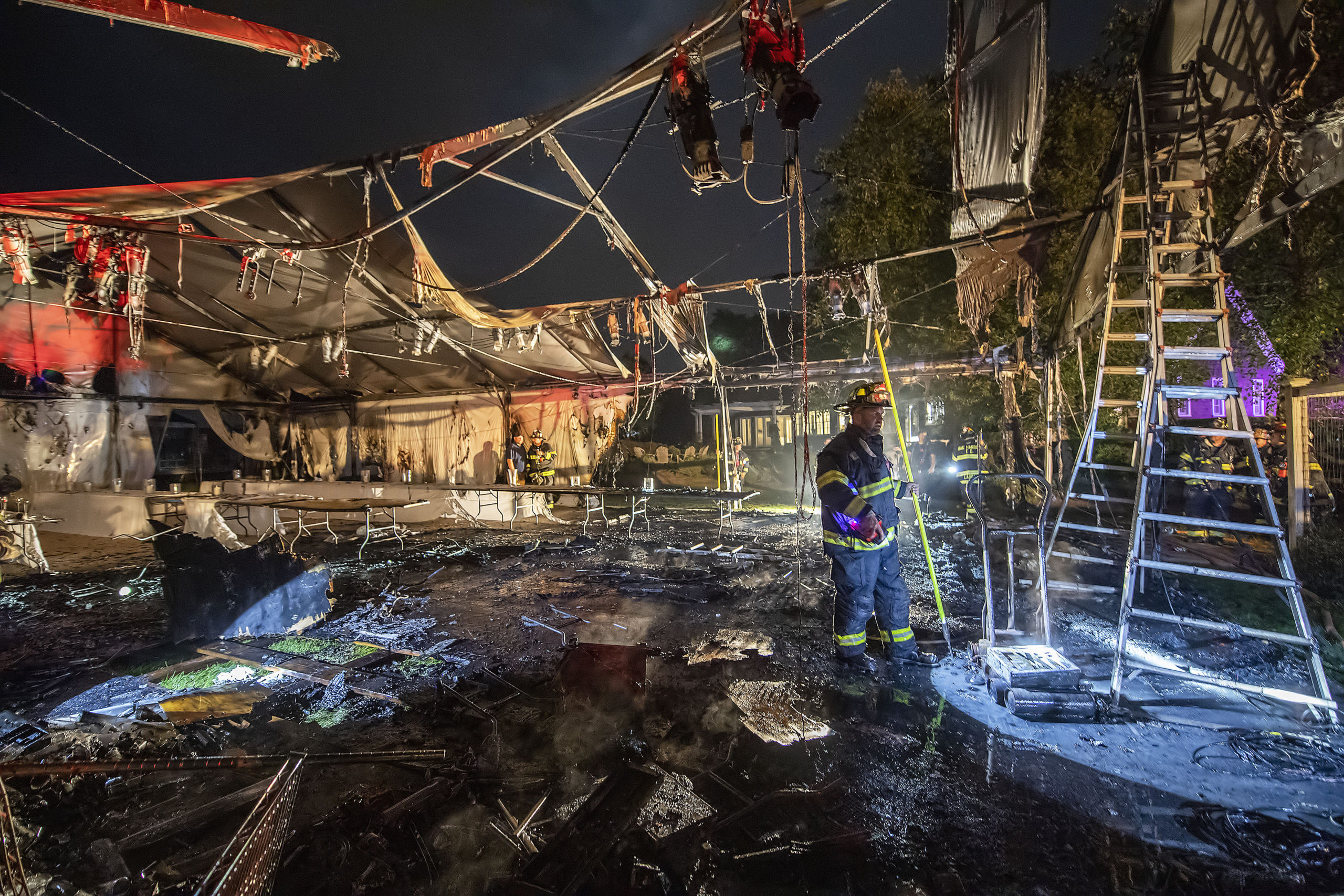 Fire swept through a large party tent Friday behind a home on Lockwood Avenue in Bridgehampton. The Bridgehampton Fire Department, with help from Sag Harbor and East Hampton firefighters, extinguished the blaze, and the party, scheduled for Saturday, went on in a second tent that had already been erected for the event. MICHAEL HELLER