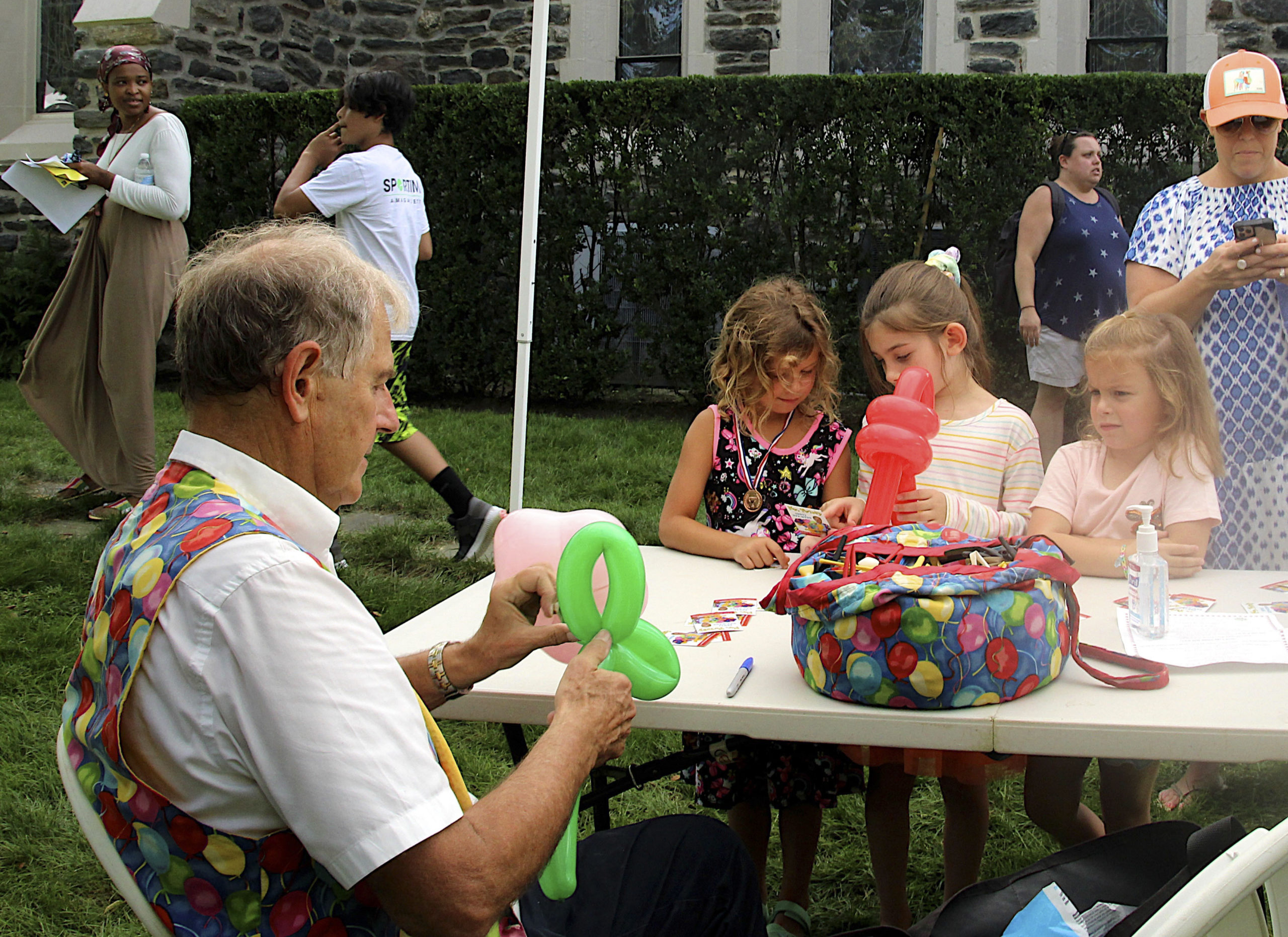 Mr. Twisty creates balloon animals at the St. Luke's Episcopal Church Fair on Saturday.  KYRIL BROMLEY