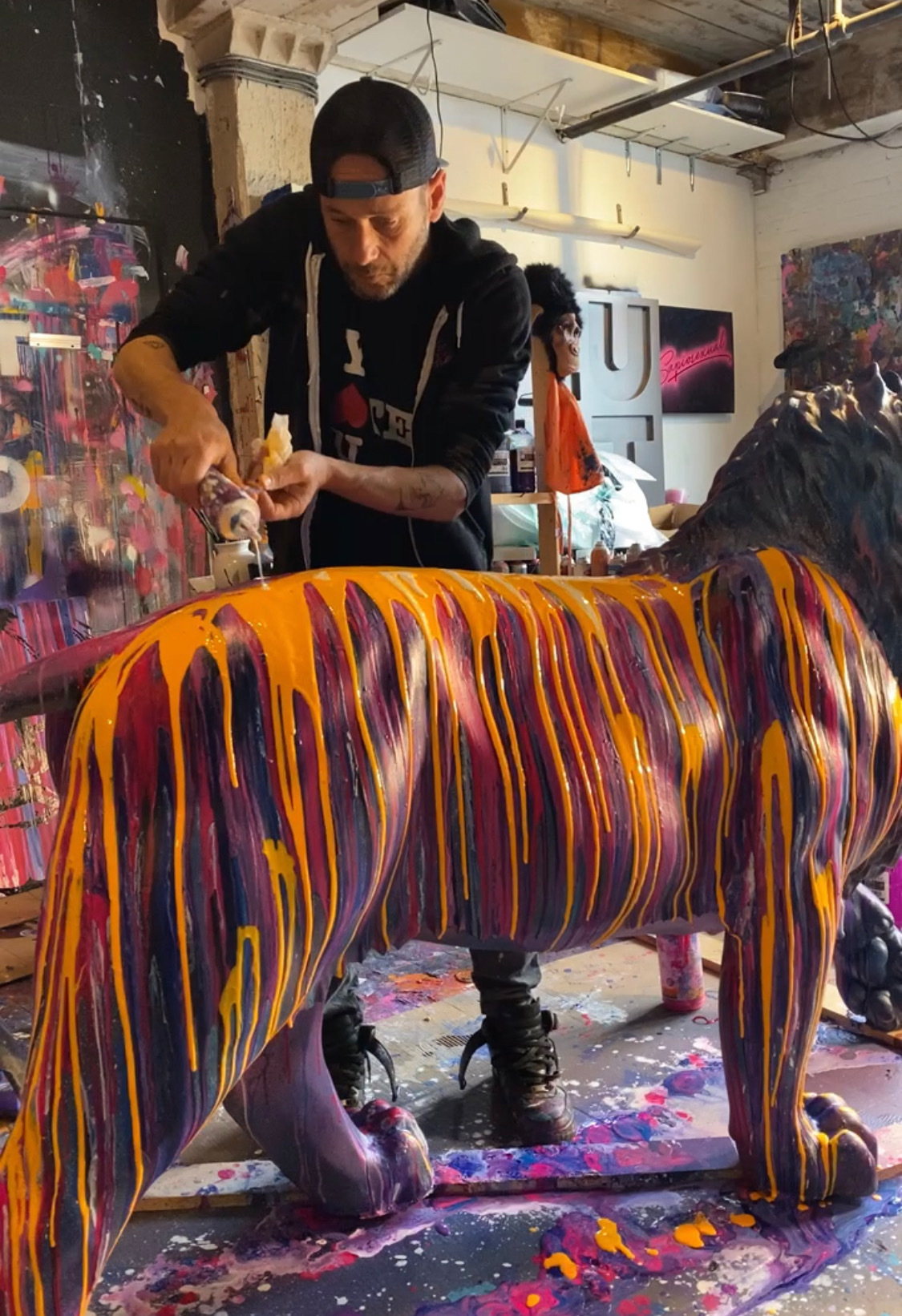 Jeremy Penn works on his lion sculpture, 