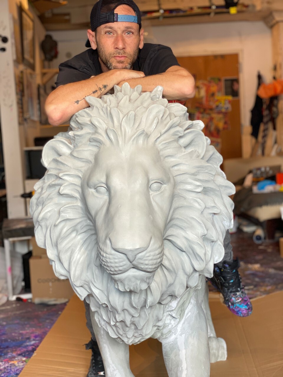 Jeremy Penn with his lion sculpture.