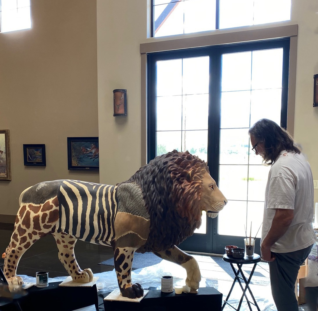 John Banovich with his lion sculpture, 