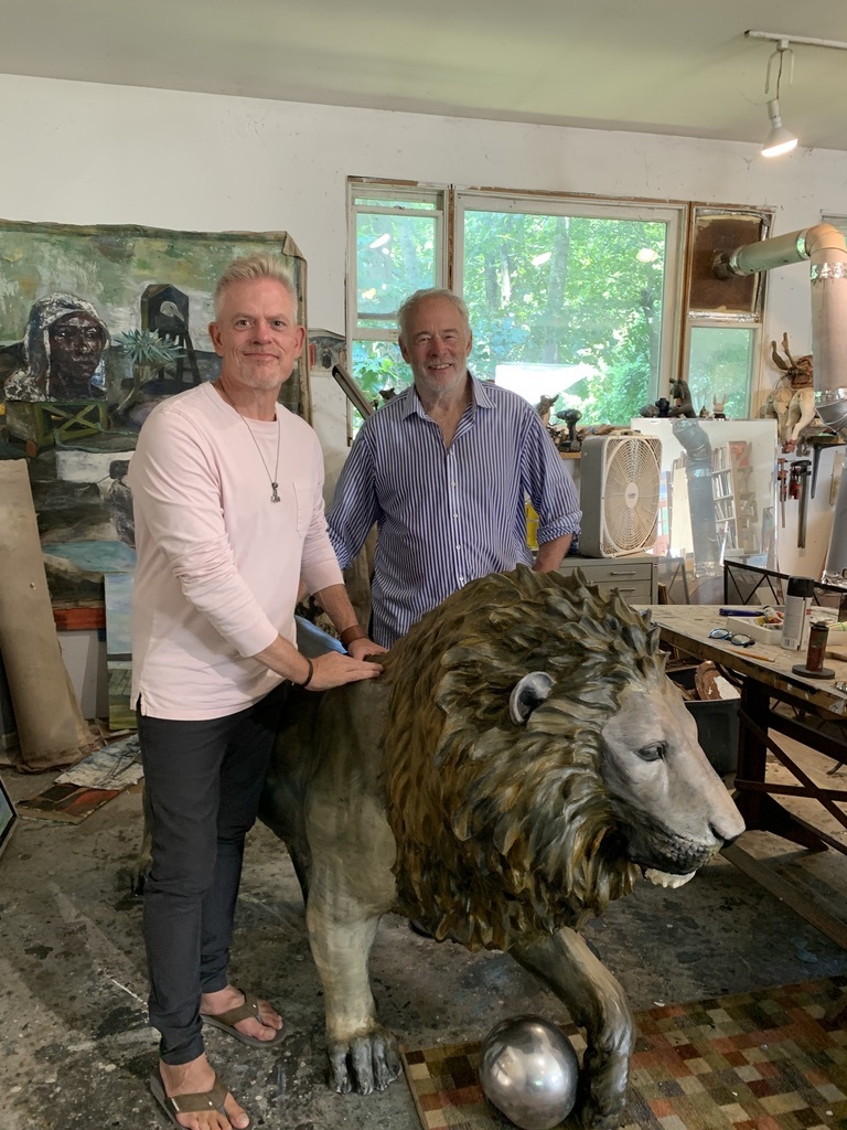 Brady Forseth, CEO of the African Community & Conservation Foundation, with artist Paton Miller and his artistic lion in his Southampton studio.