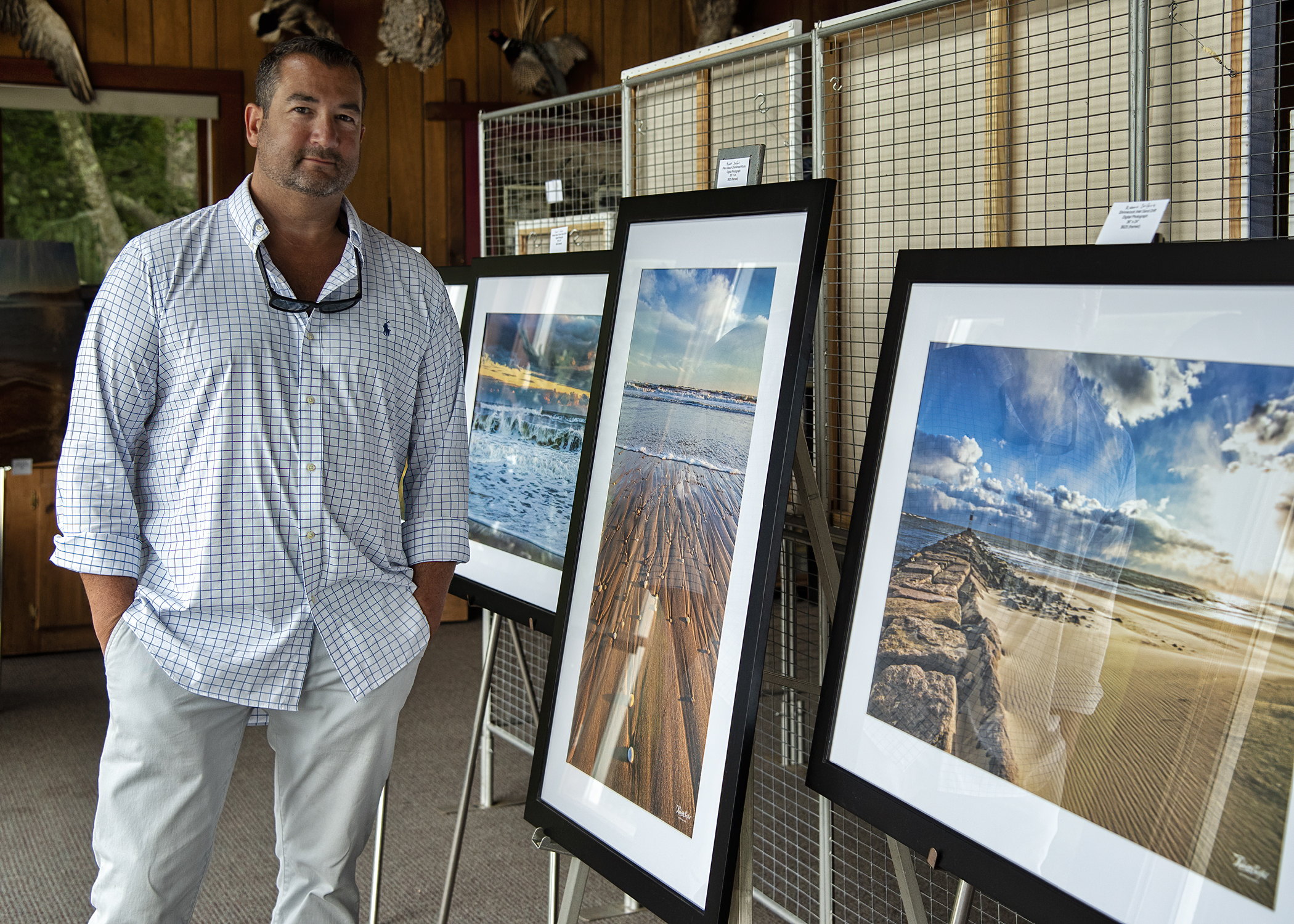 Rob Seifert, by his photography, at an artists showcase, “Visions of Nature Art Exhibition,” curated by Elizabeth Hartman of HartmanonHudson.com, at the Quogue Wildlife Refuge on Saturday. A portion of the evening’s sales benefited the refuge.