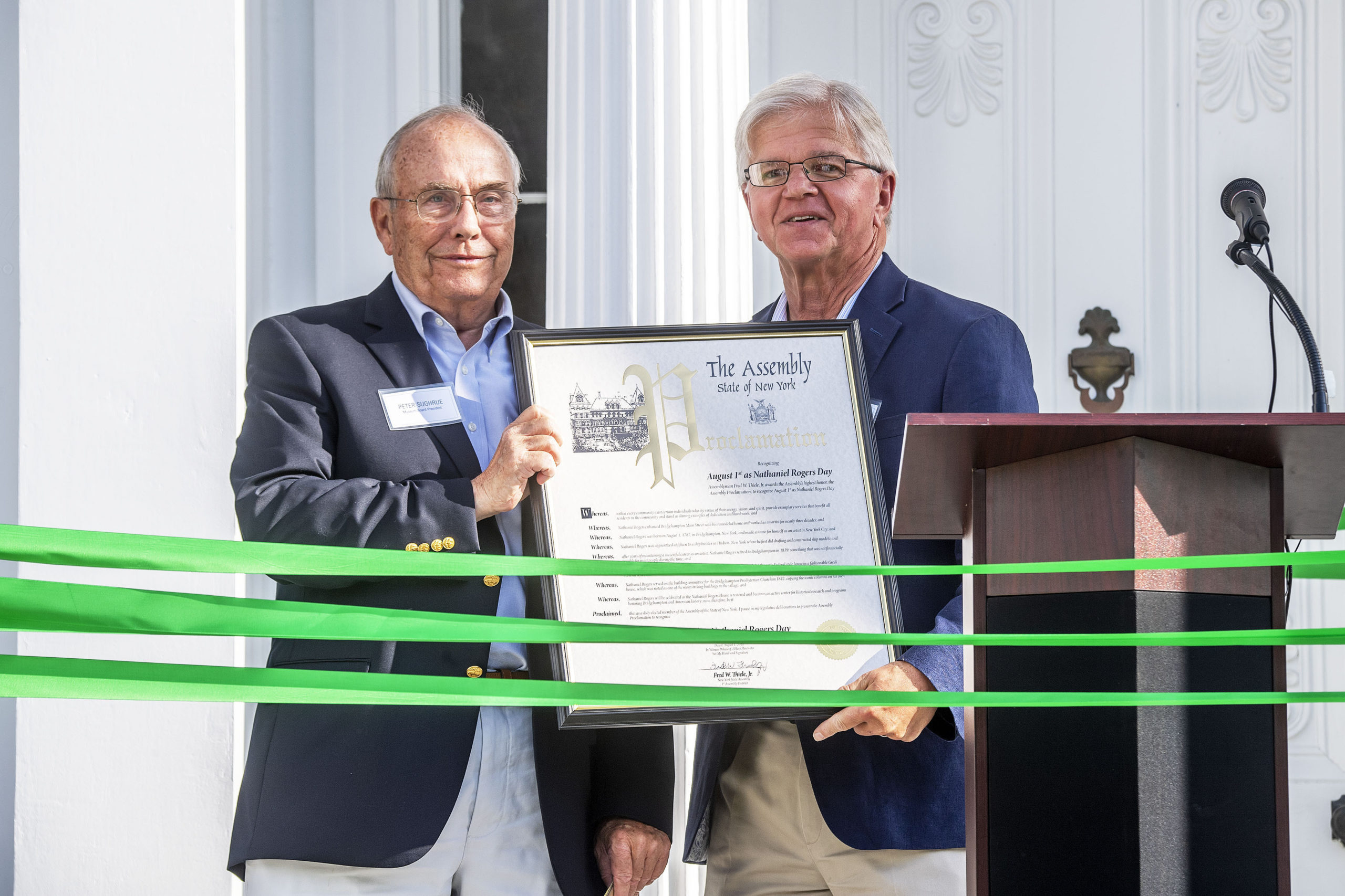 New York State Assemblyman Fred Thiele presents Bridgehampton Museum Board President Peter Sughrue with a proclamation naming August 1st as Nathaniel Rogers Day during a ribbon-cutting ceremony that was held to inaugurate the new, completely refurbished Nathaniel Rogers House at the corner of Ocean Road and Montauk Highway on Sunday. MICHAEL HELLER