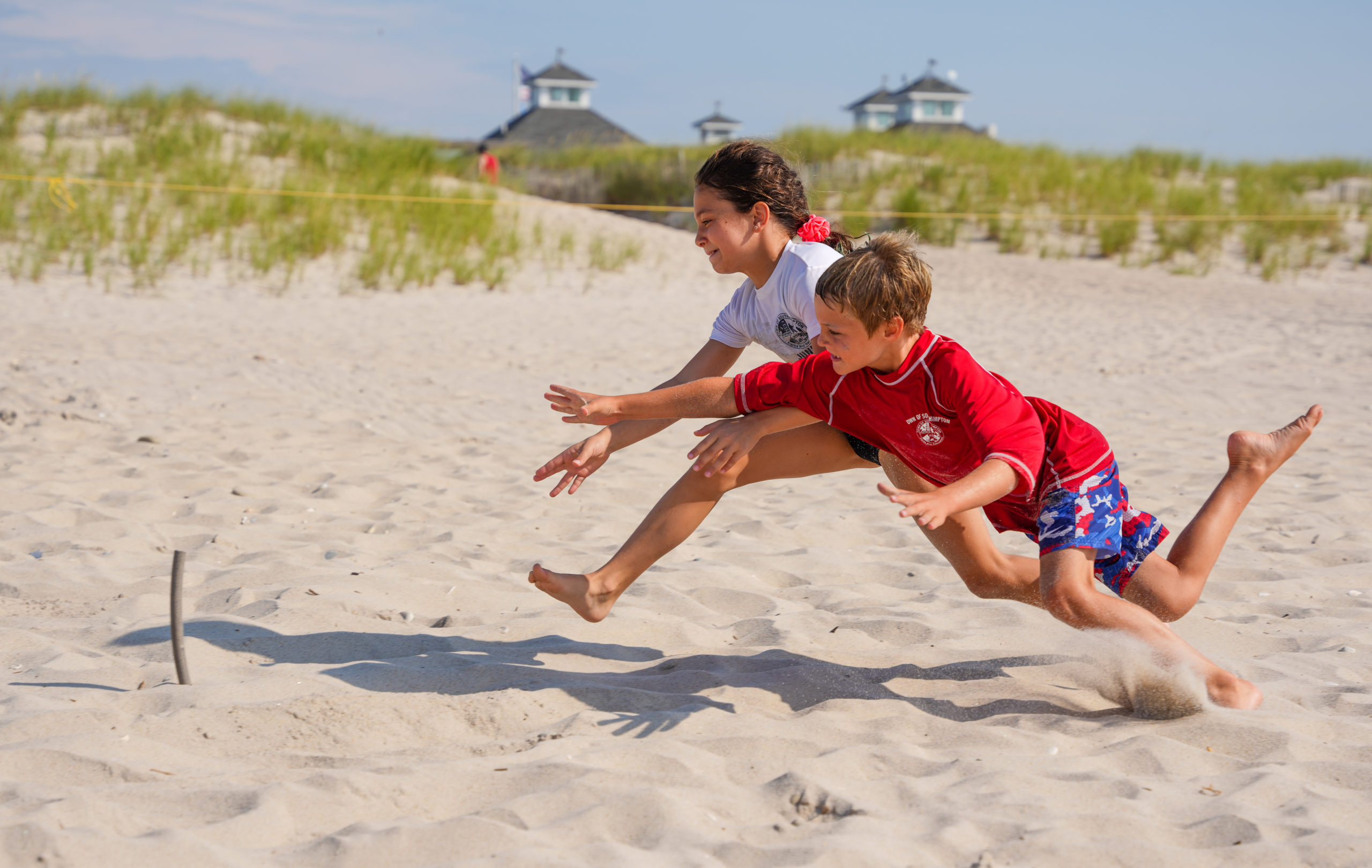 A pair of junior guards battle it out for a beach flag.