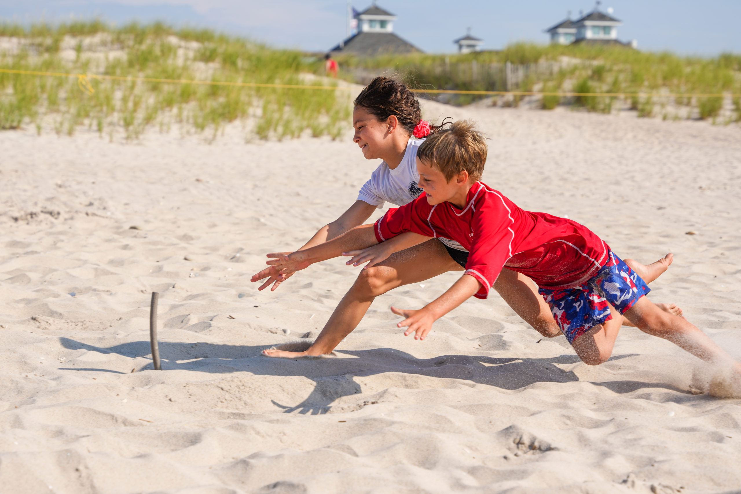 A pair of junior guards battle it out for a beach flag.