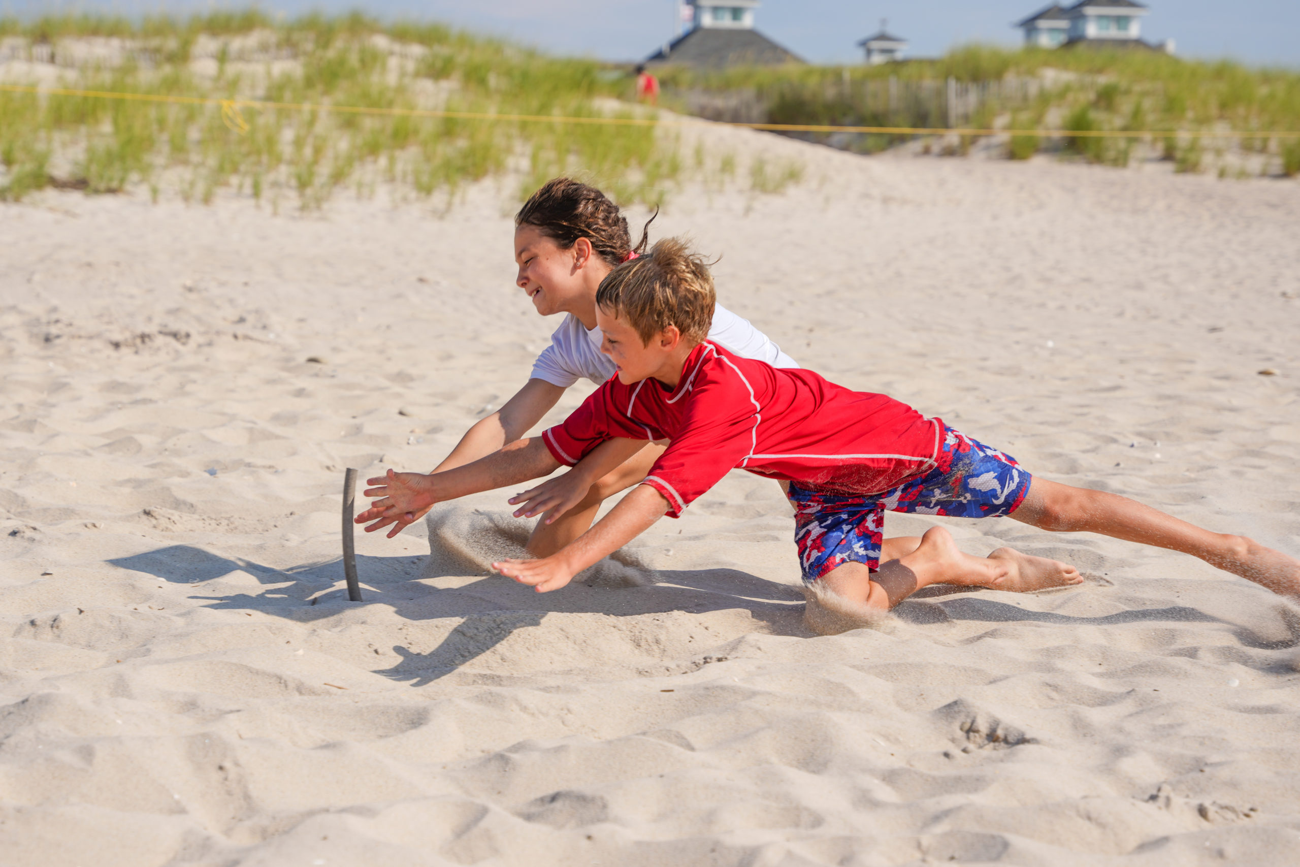 A pair of junior guards battle it out for a beach flag.