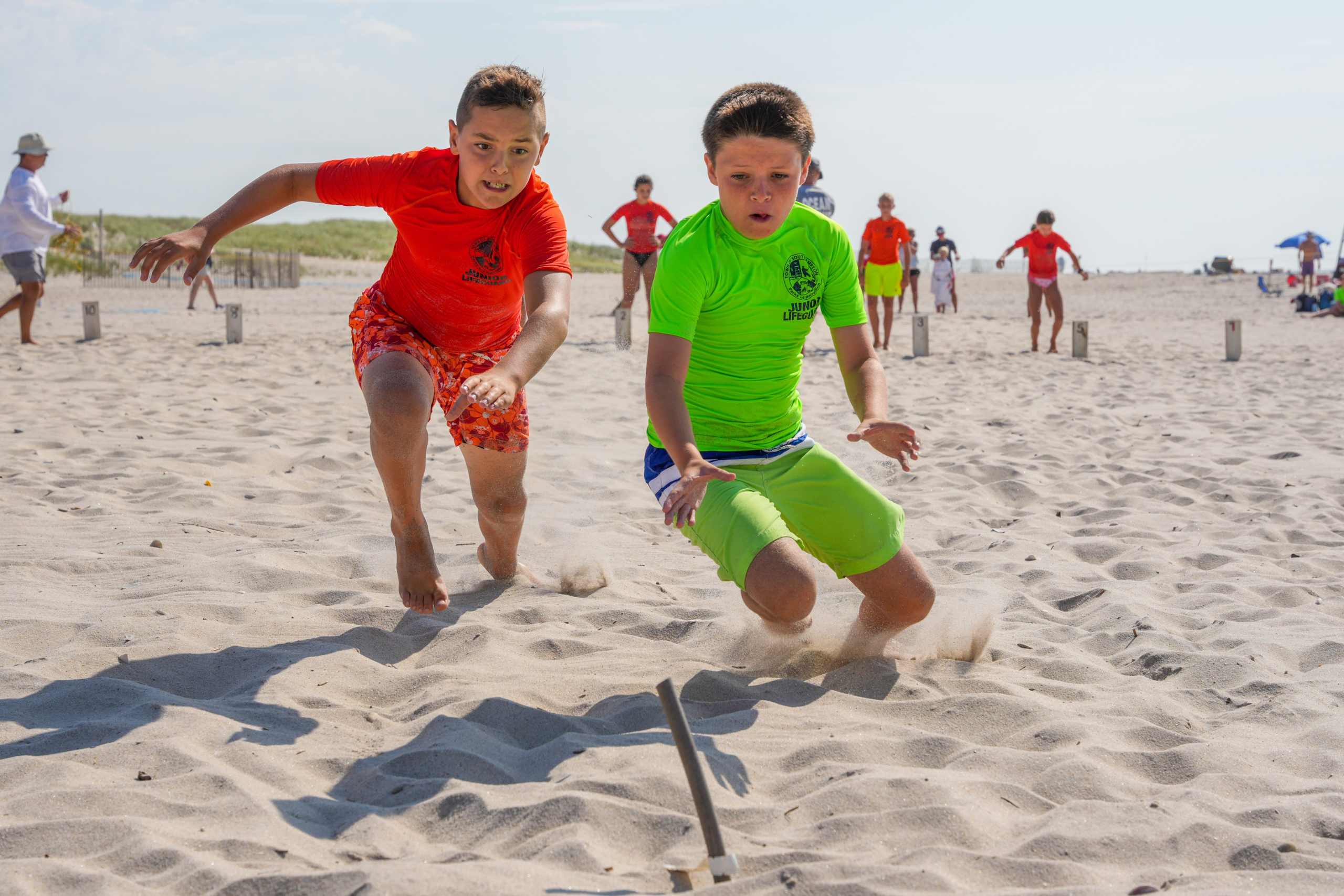 James Garvin, right, and another junior guard battle for a beach flag.