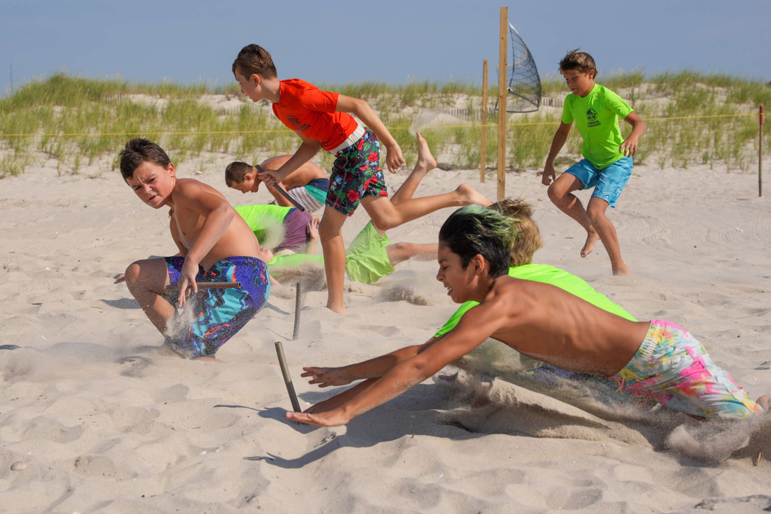 Junior guards battle it out for a beach flag.