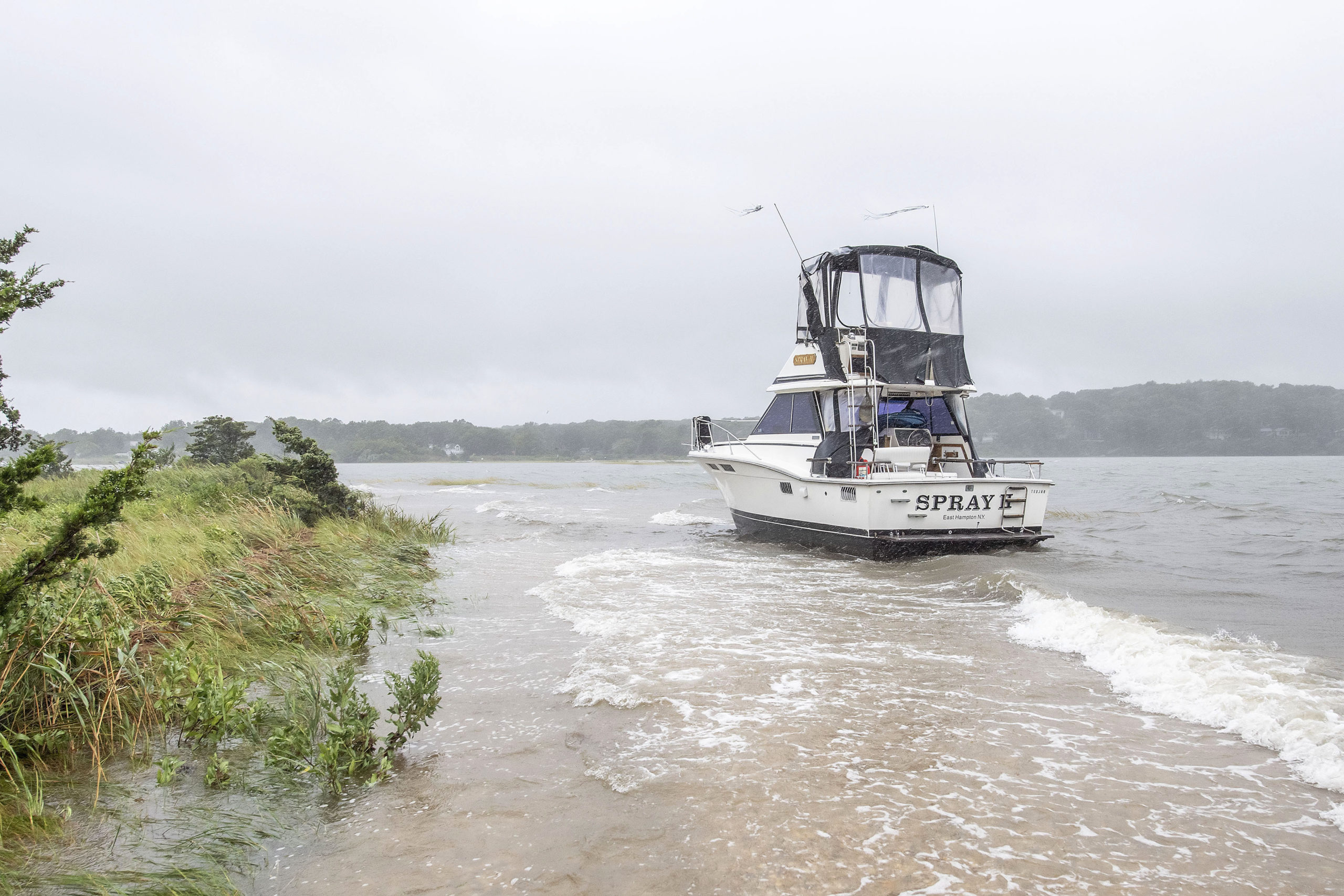 The Spray II broke free of its moorings and washed ashore off Breeze Hill Road during Tropical Storm Henri on Sunday.                MICHAEL HELLER