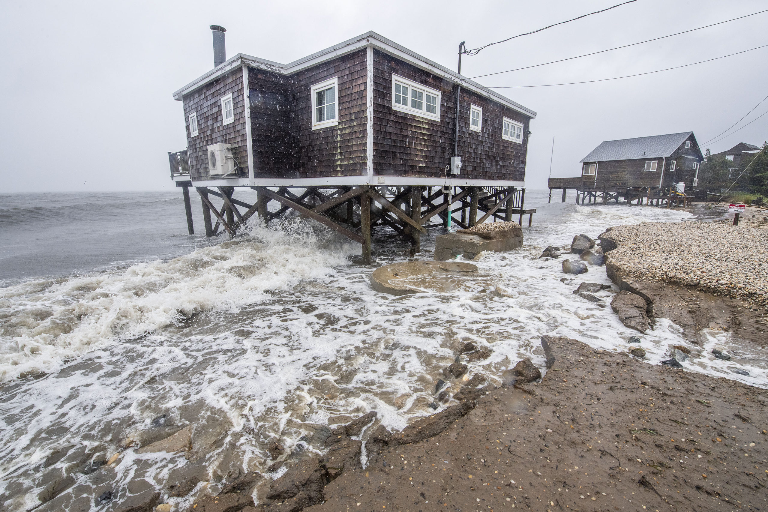 The storm surge breached and poured onto the roadway at 221 Gerard Drive during Tropical Storm Henri on Sunday.   MICHAEL HELLER