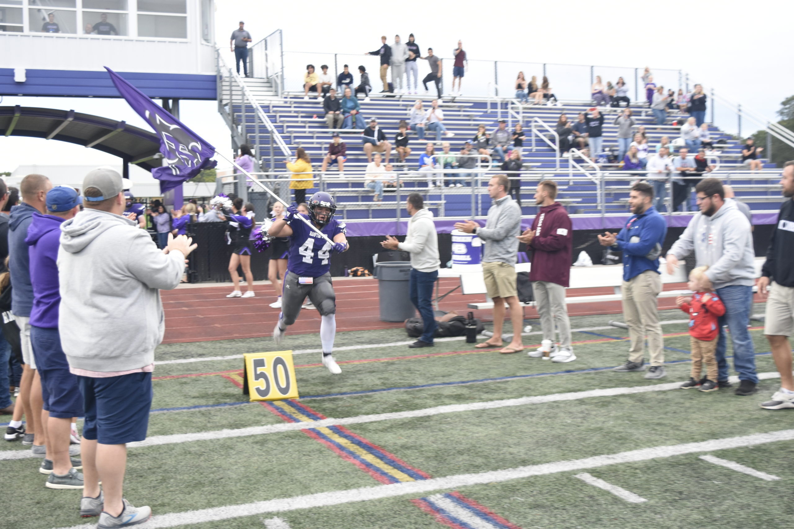 Surrounded by alumni, Cooper Shay leads the Baymen out onto the field just before Friday's game against Greenport/Mattituck/Southold.