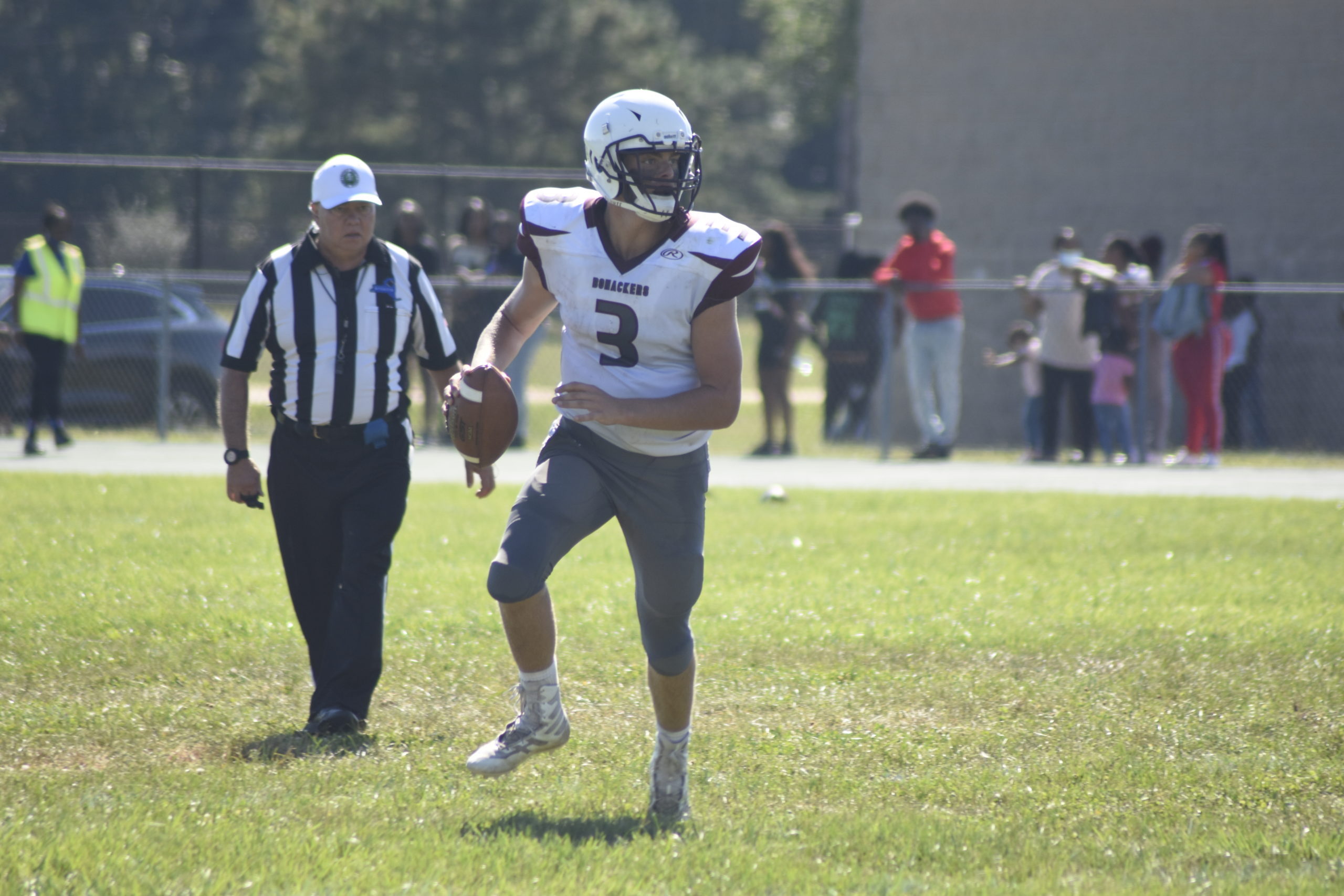 Bonac quarterback Charlie Corwin scans upfield for an open receiver.