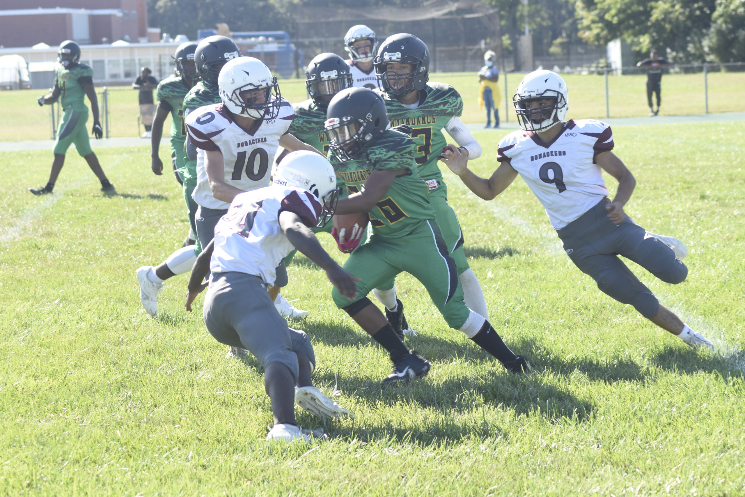 Mike Hill (24), Dan Lester (10) and Santi Maya chase down a Wyandanch player.