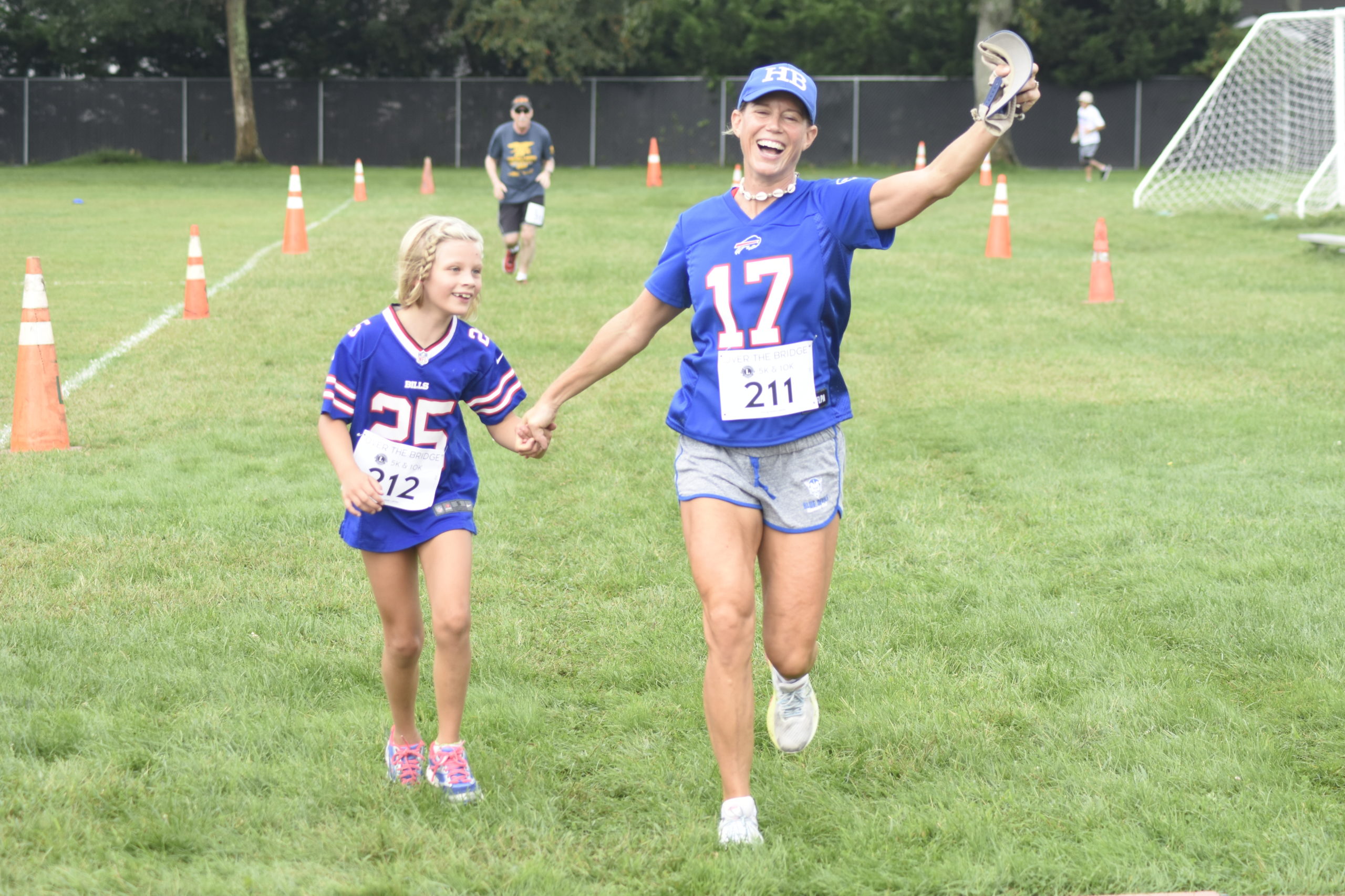 Anabel, left, and Jessica Ramsay of Hampton Bays cross the finish line together.