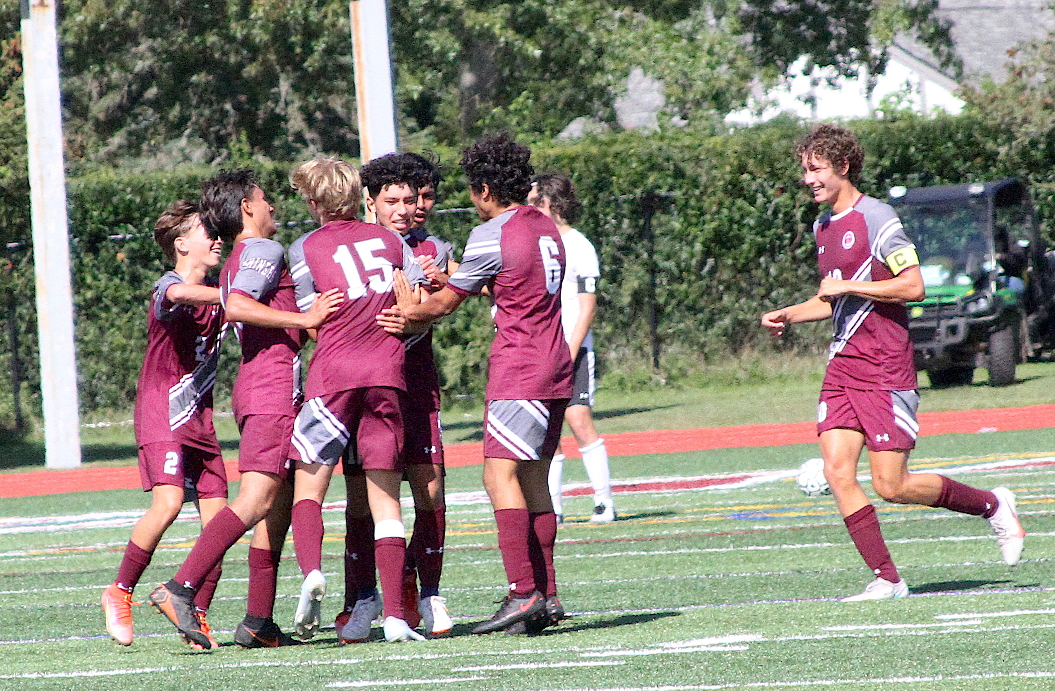 Southampton sophomore midfielder Danny Bustamante is surrounded by his teammates after scoring the Mariners' third goal of the game against Babylon September 25. DESIRÉE KEEGAN
