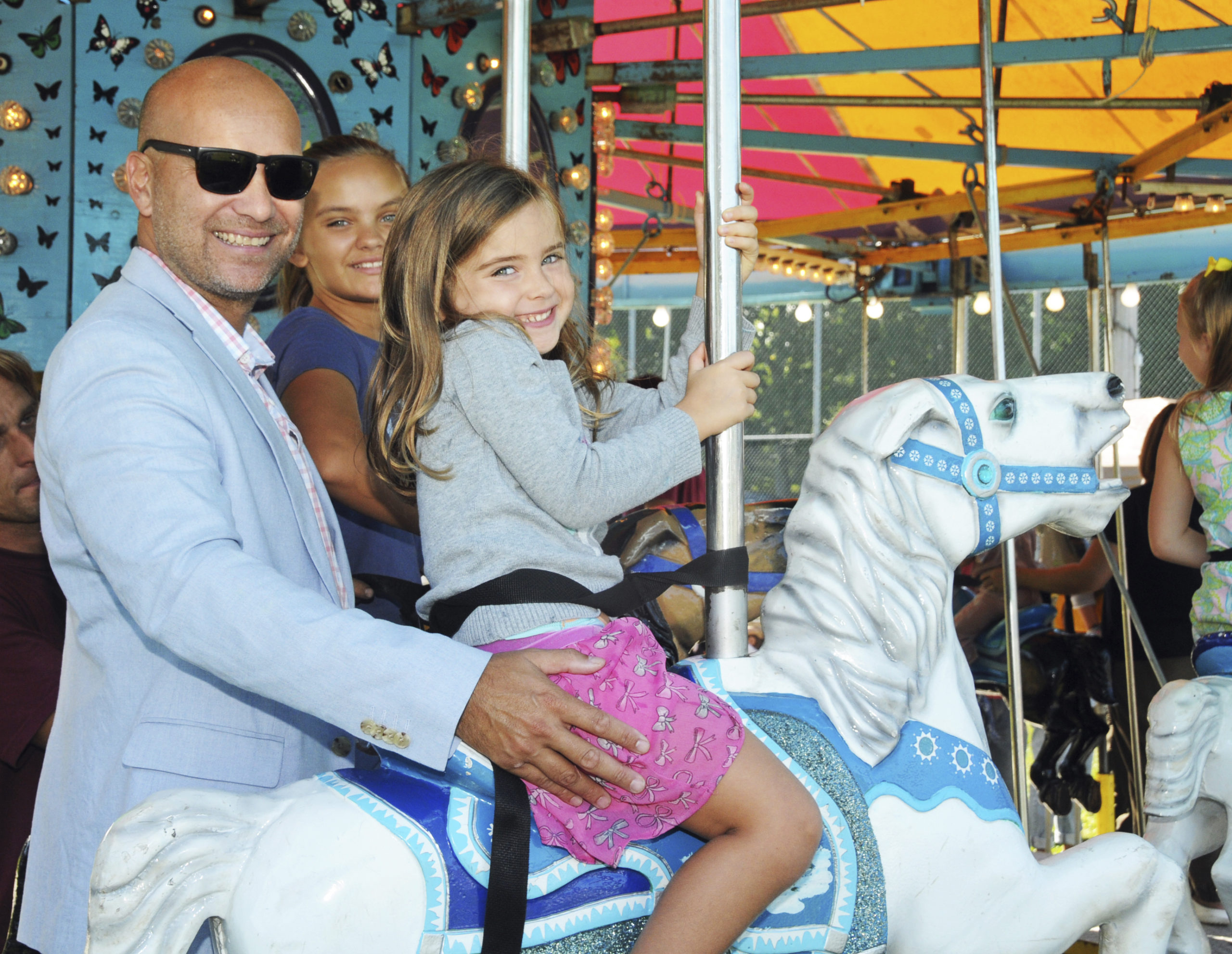 David Lys with daughters Brynley and Brooke on the carousel.