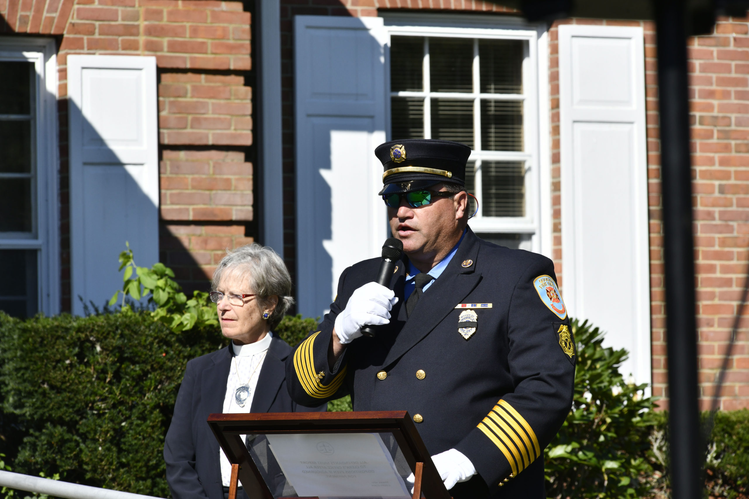 Quogue Fire Department Ex-Chief Chris Osborne welcomes the crowd the memorial rededication ceremony on Saturday.