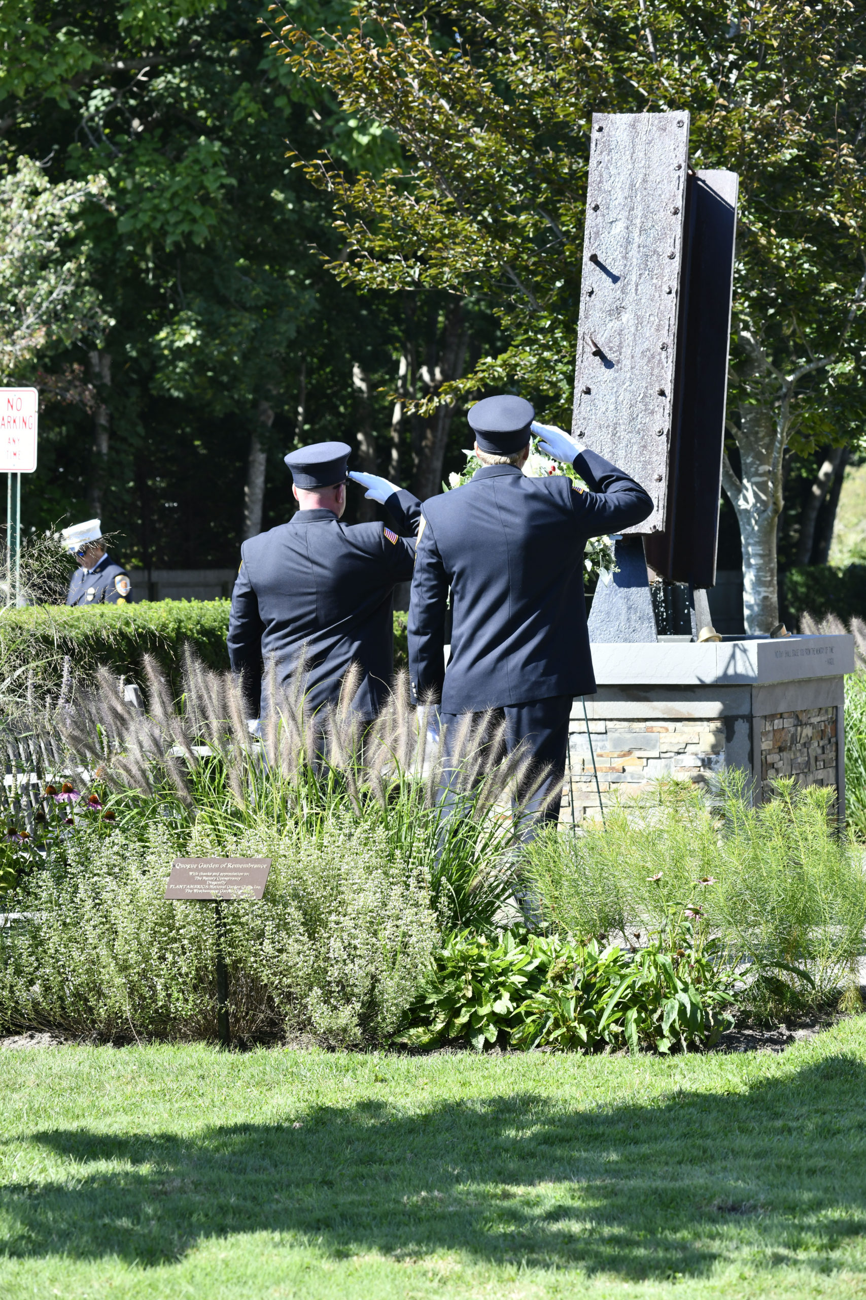 Quogue Firefighters salute the memorial on Saturday.