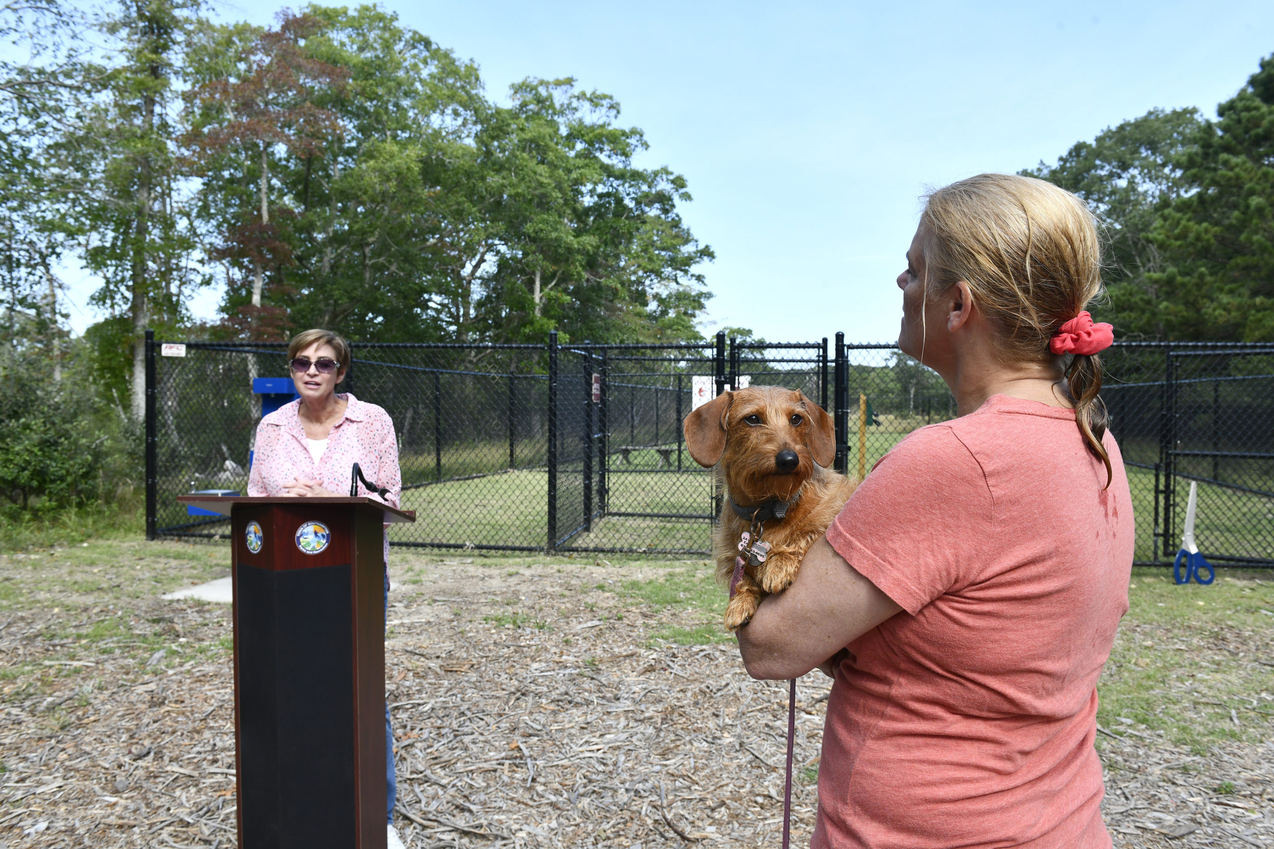 Southampton Town Councilwoman Julie Lofstad welcomes guests to the opening of he Off the Leash Dog Park in East Quogue on Monday morning. The park is located at Pine Neck Marina, 22 Josiah Foster Path in East Quogue.   DANA SHAW