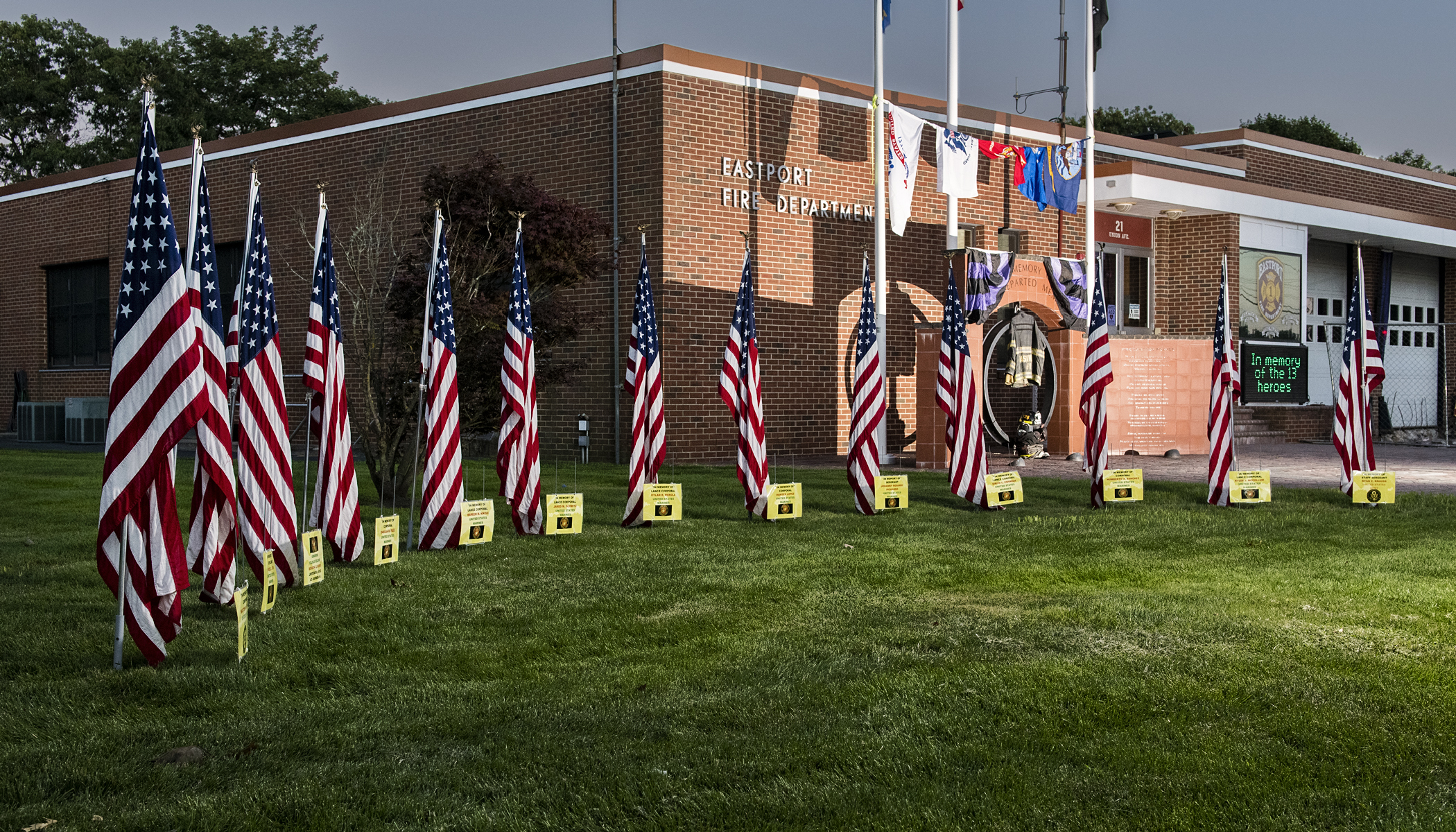 Members of the Eastport Fire Department installed a flag display in front of its firehouse last week. The display honors the one U.S. Navy sailor, one Army soldier, and 11 U.S. Marines killed protecting Americans and Afghan allies in Kabul last week.