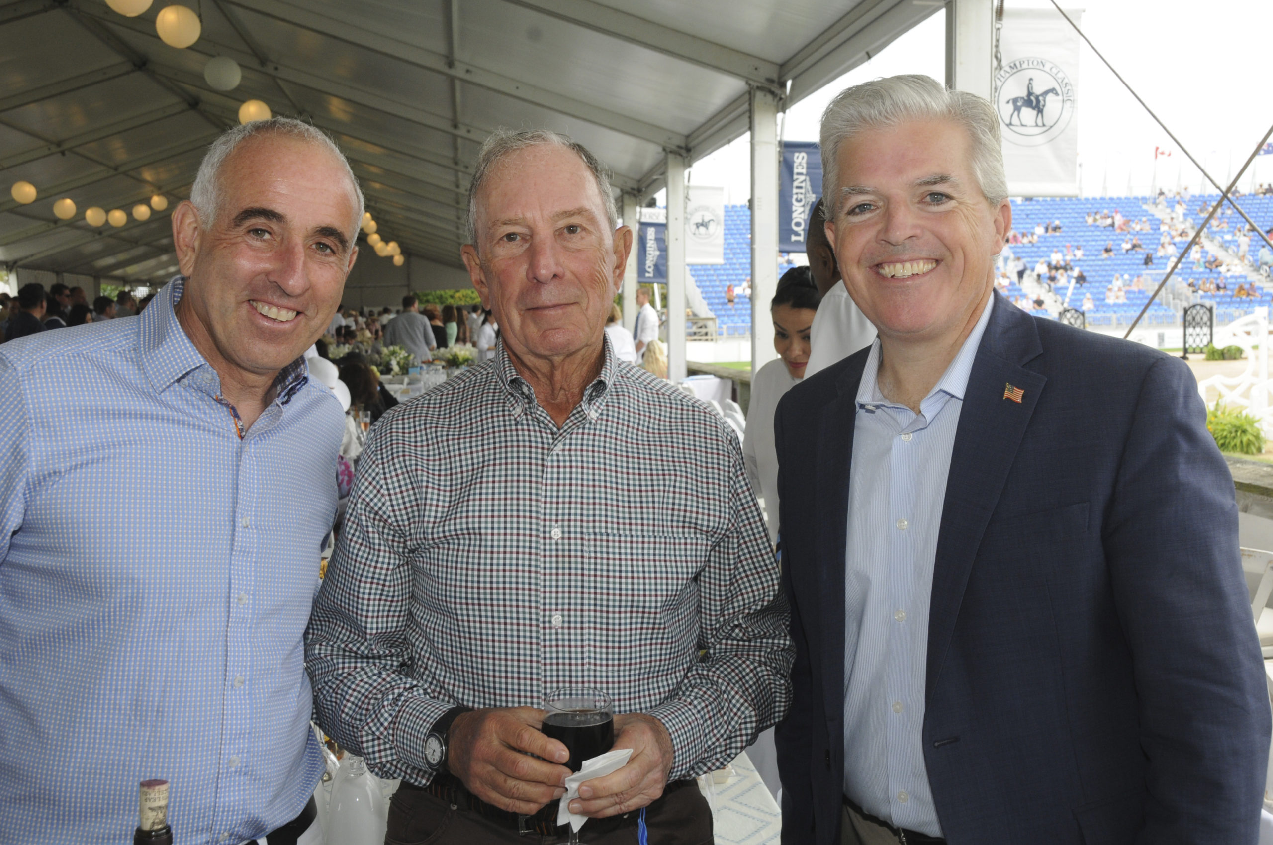 Jay Schneiderman, Michael Bloomberg and Steve Bellone in the tent at the Hampton Classic Grand Prix on Sunday afternoon.   RICHARD LEWIN